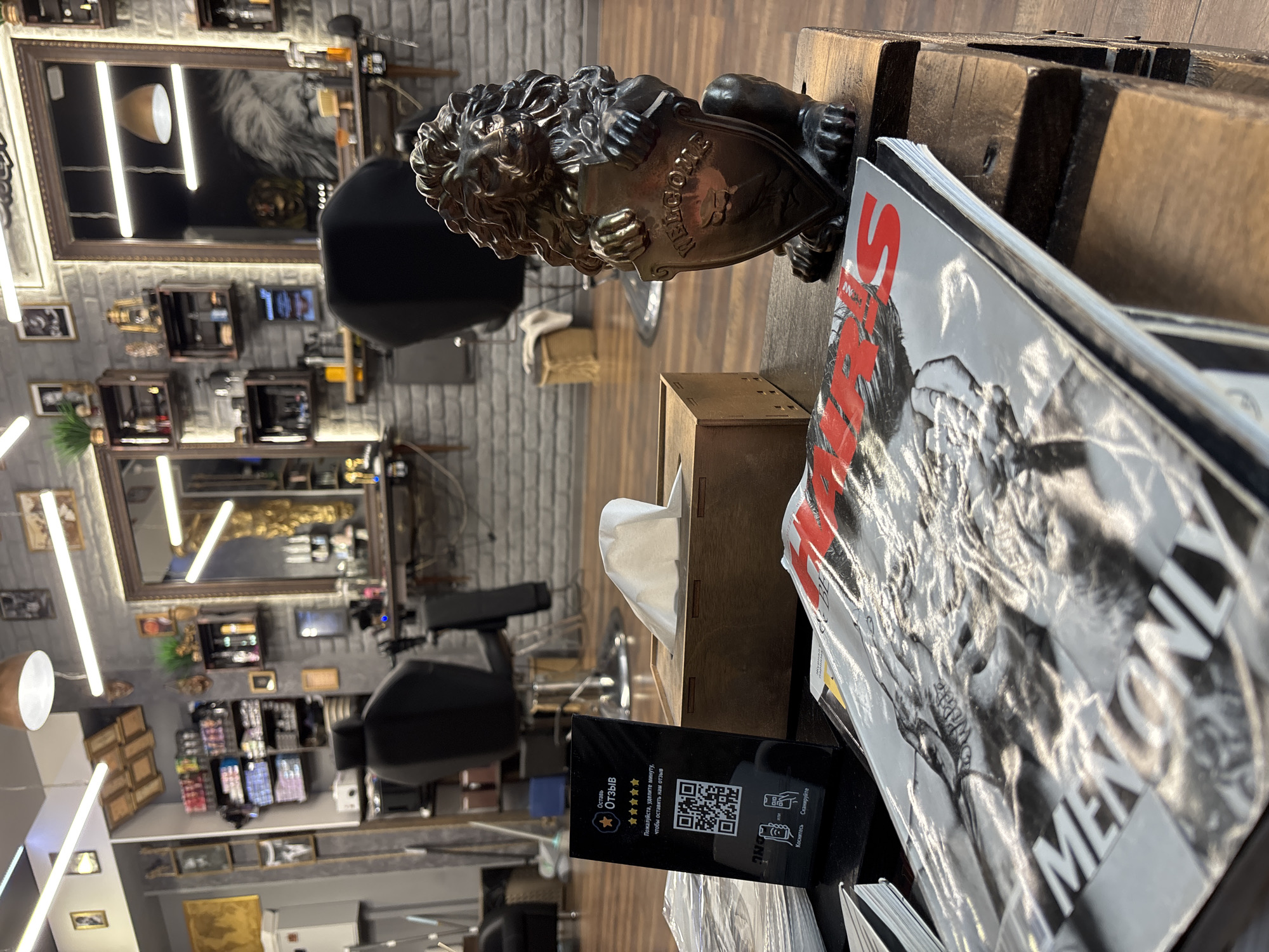 Minsk barbershop interior observed with lion statuette, magazines