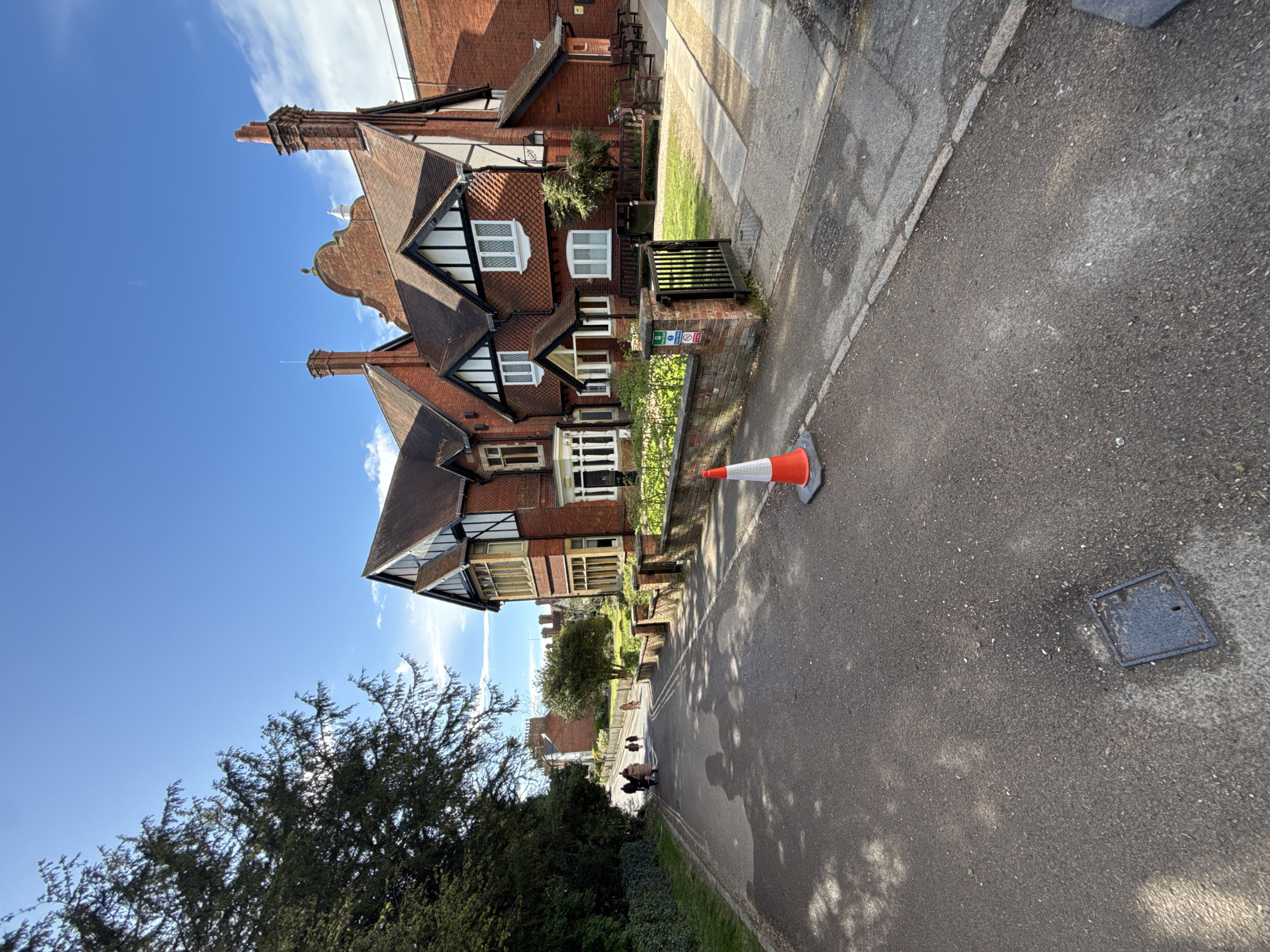Tourist documents Tudor architecture during Berkhamsted town center stroll