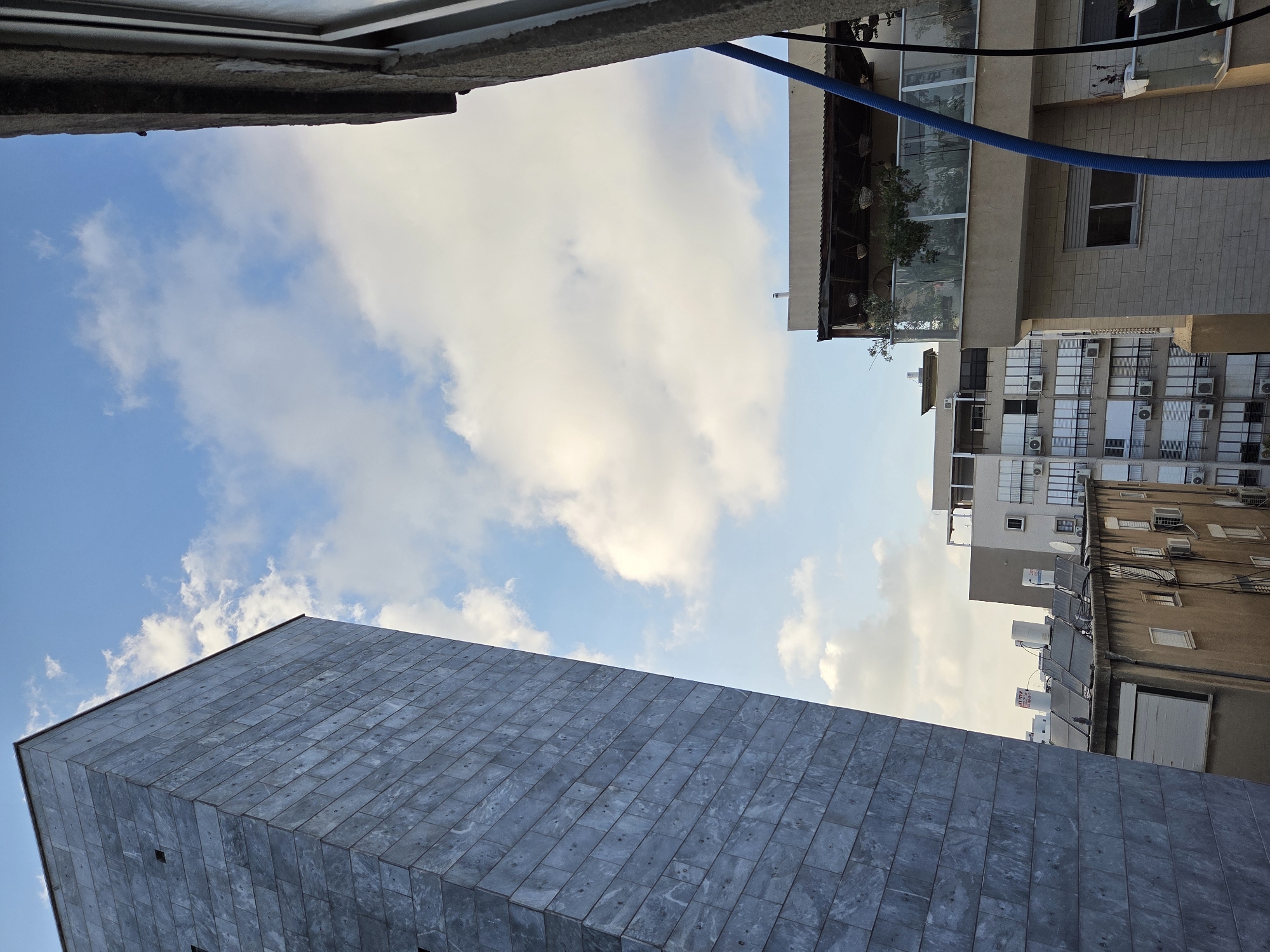 Street-level buildings and a YouTube browse session in Rishon LeZion