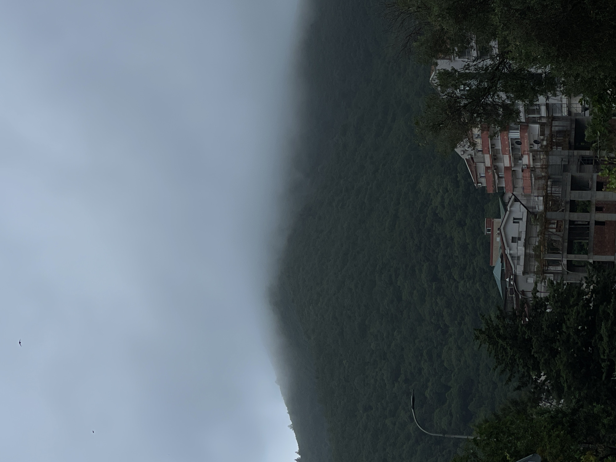 Foggy mountain landscape with buildings observed Saturday morning