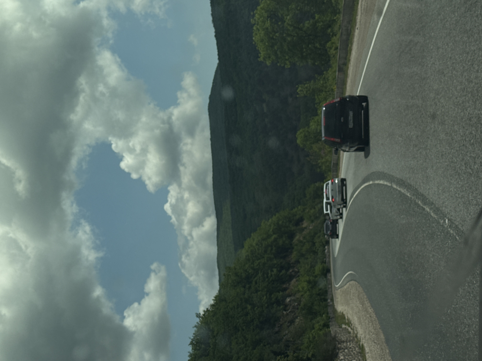 Three cars navigate winding road in Balaklava District, Ukraine