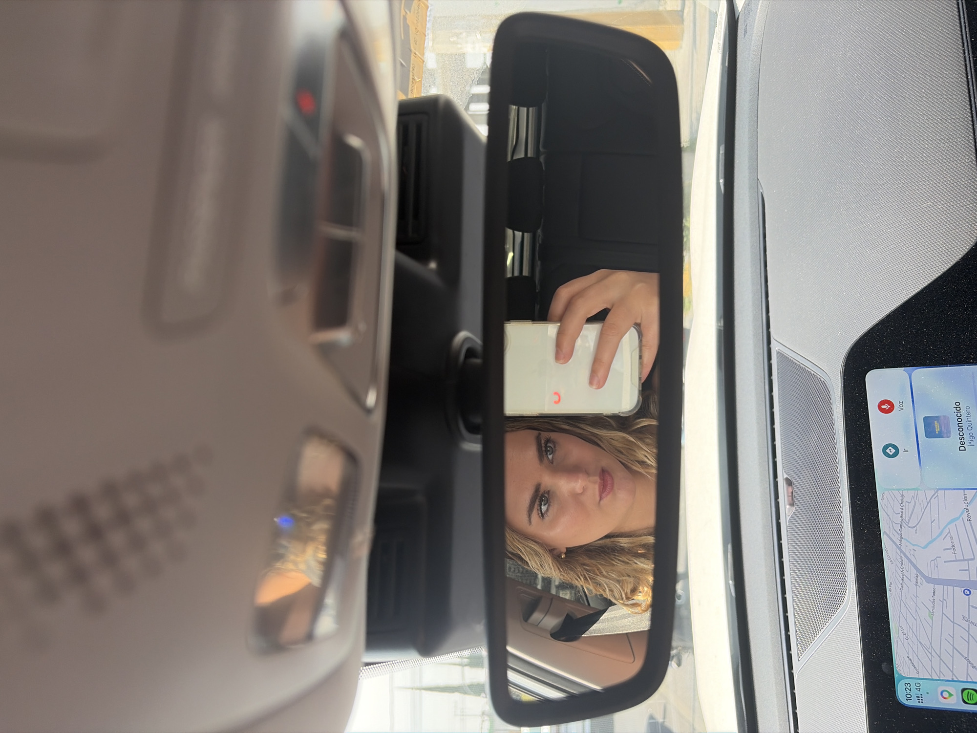 Woman takes selfie in car passenger seat in Puebla