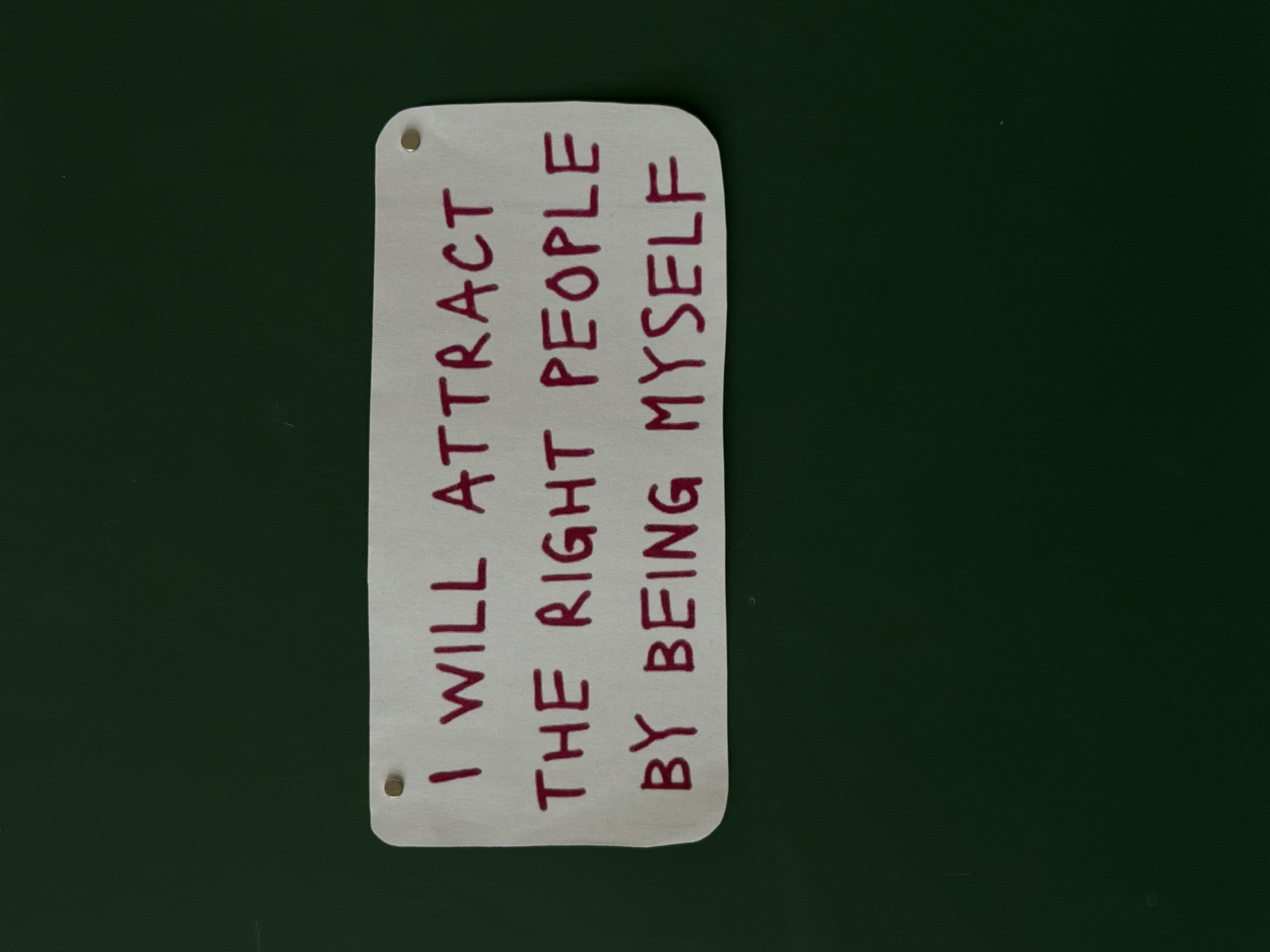 Motivational signs with self-affirmation messages displayed on green walls