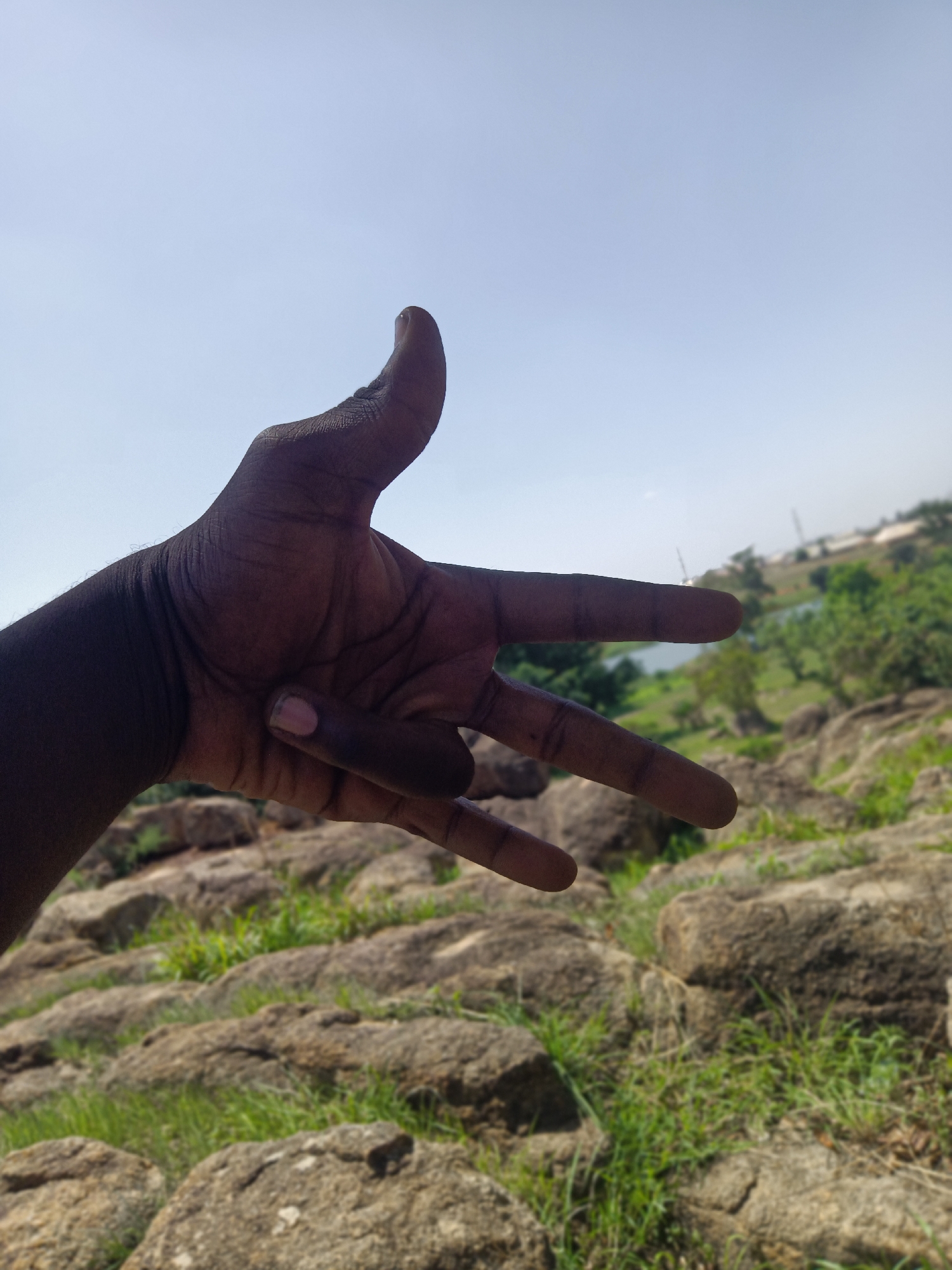 Visitors photograph rocky hillside exploration in Du, Nigeria