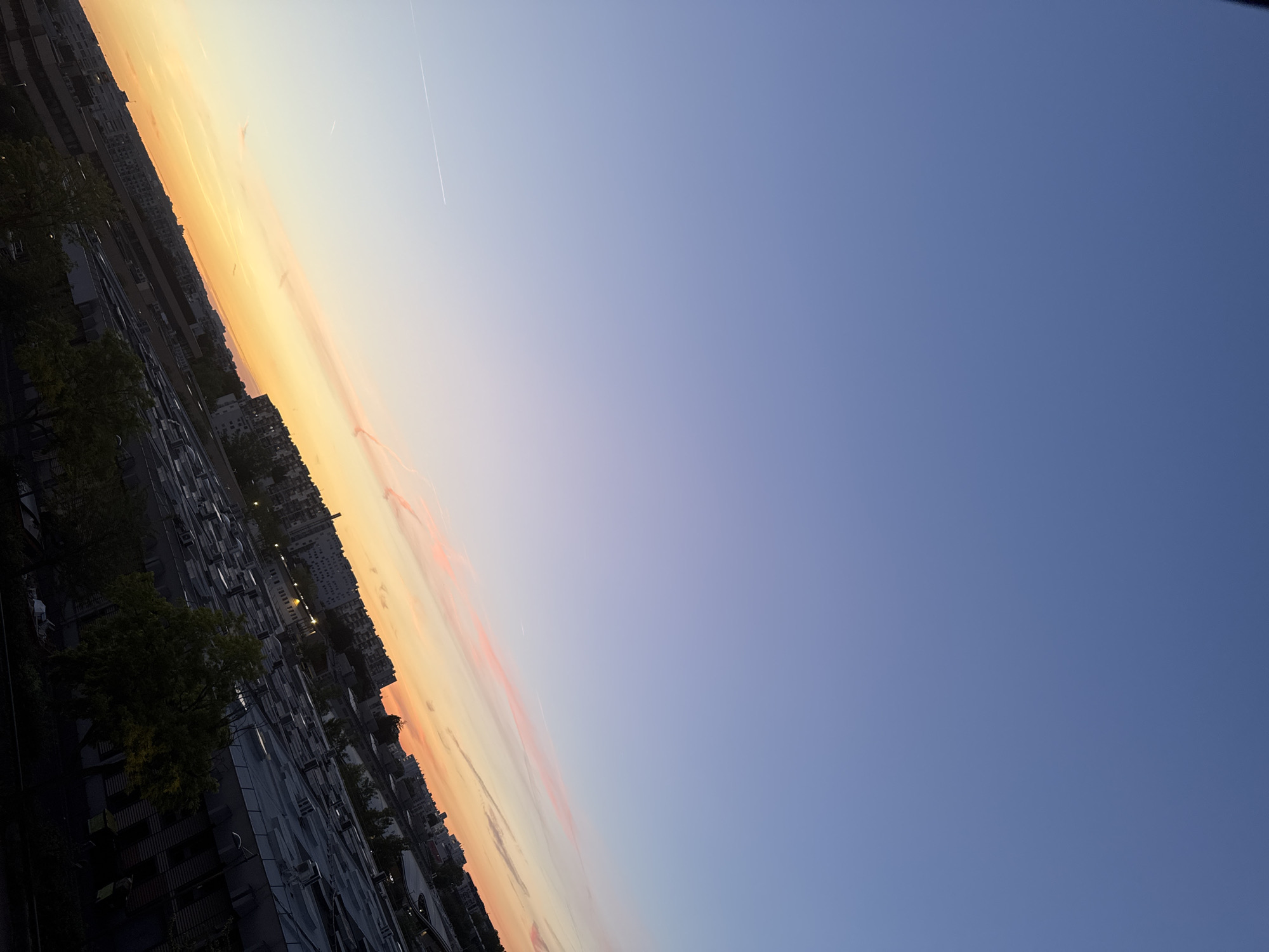 City twilight to night transition with distant firework displays
