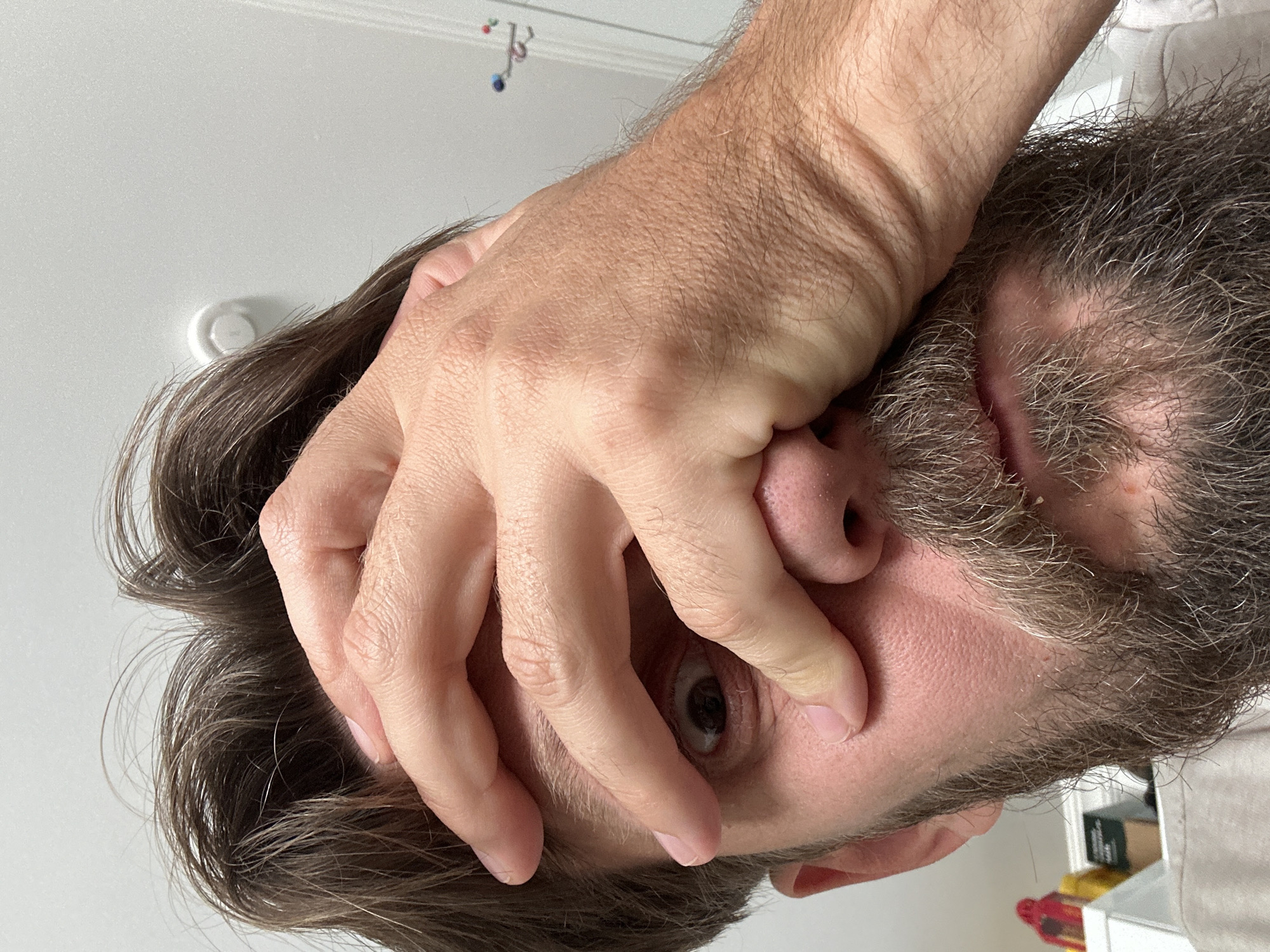 Close-up selfie with hands partially covering face, Fethiye