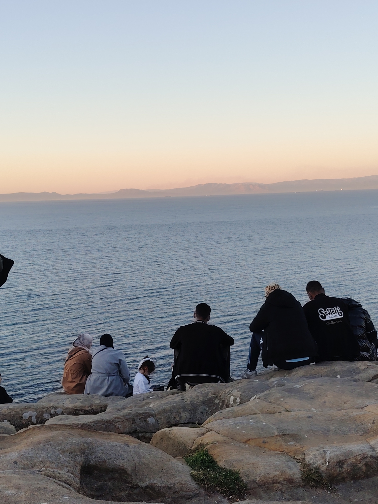 Group gathers on rocky outcrop overlooking Strait of Gibraltar