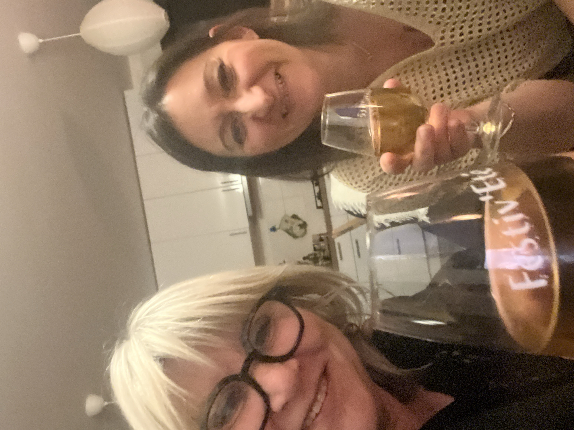 Women share drinks at indoor gathering in Chambœuf
