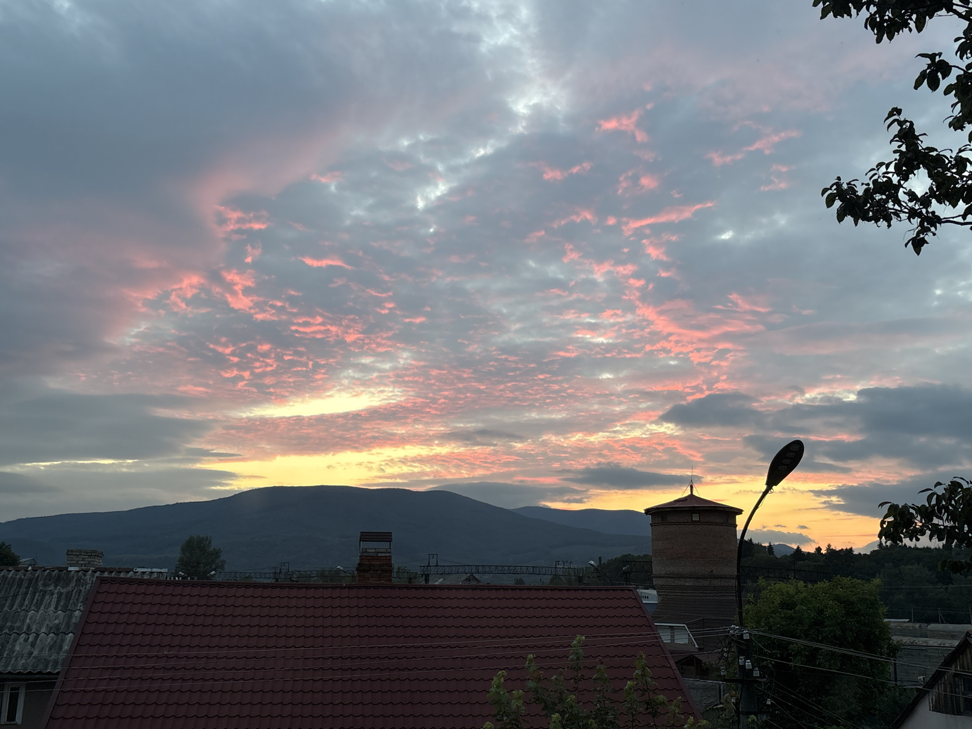 Sunset clouds over a rural mountain town