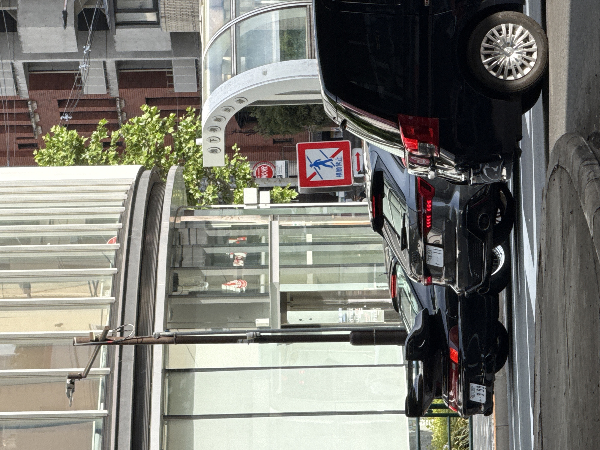 Black van parked near pedestrian crossing in Minato, Japan