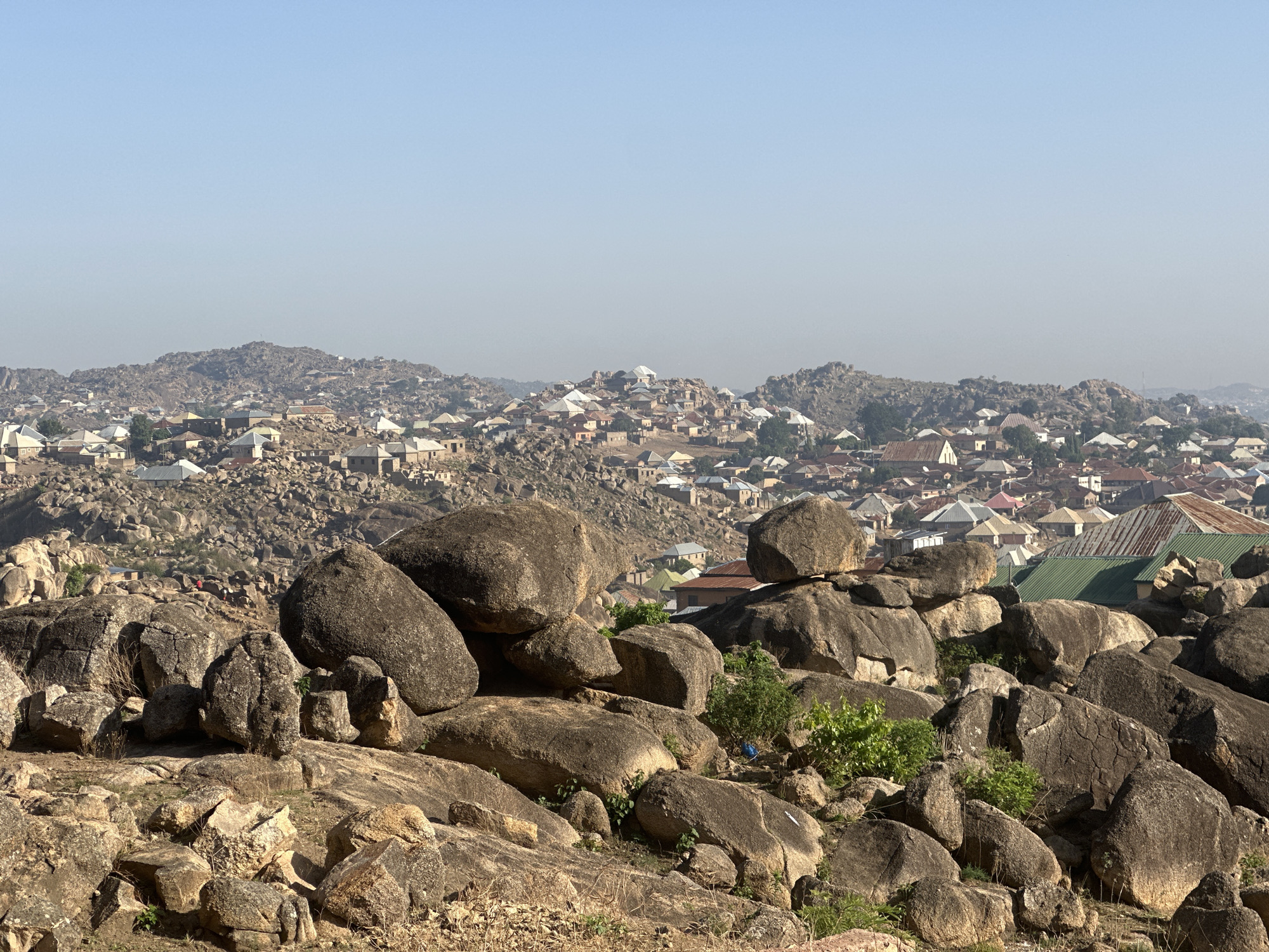 Morning life unfolds across Jos Nigeria's rocky landscape