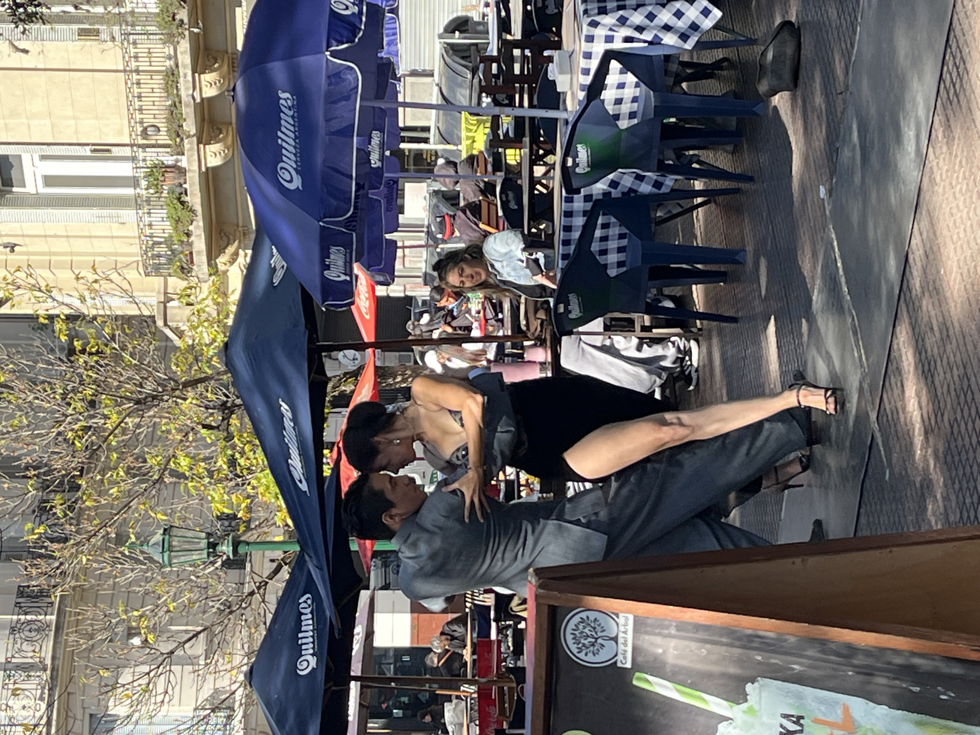 Tango couple dances in Buenos Aires street plaza