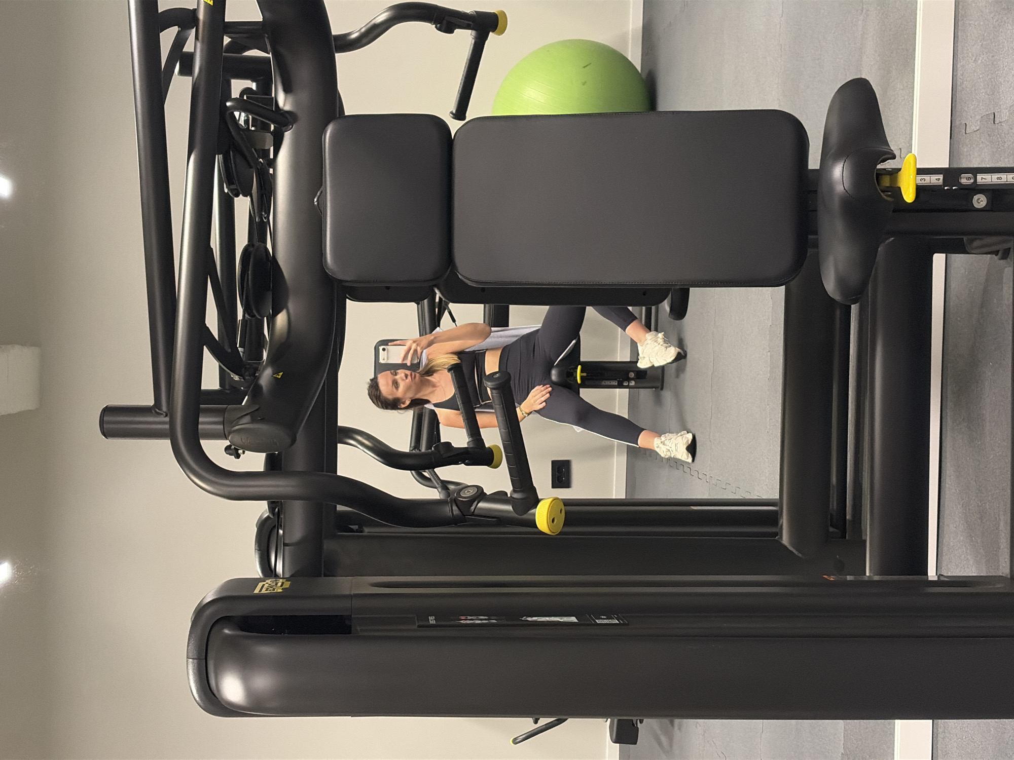 Woman documents gym session with smartphone selfies