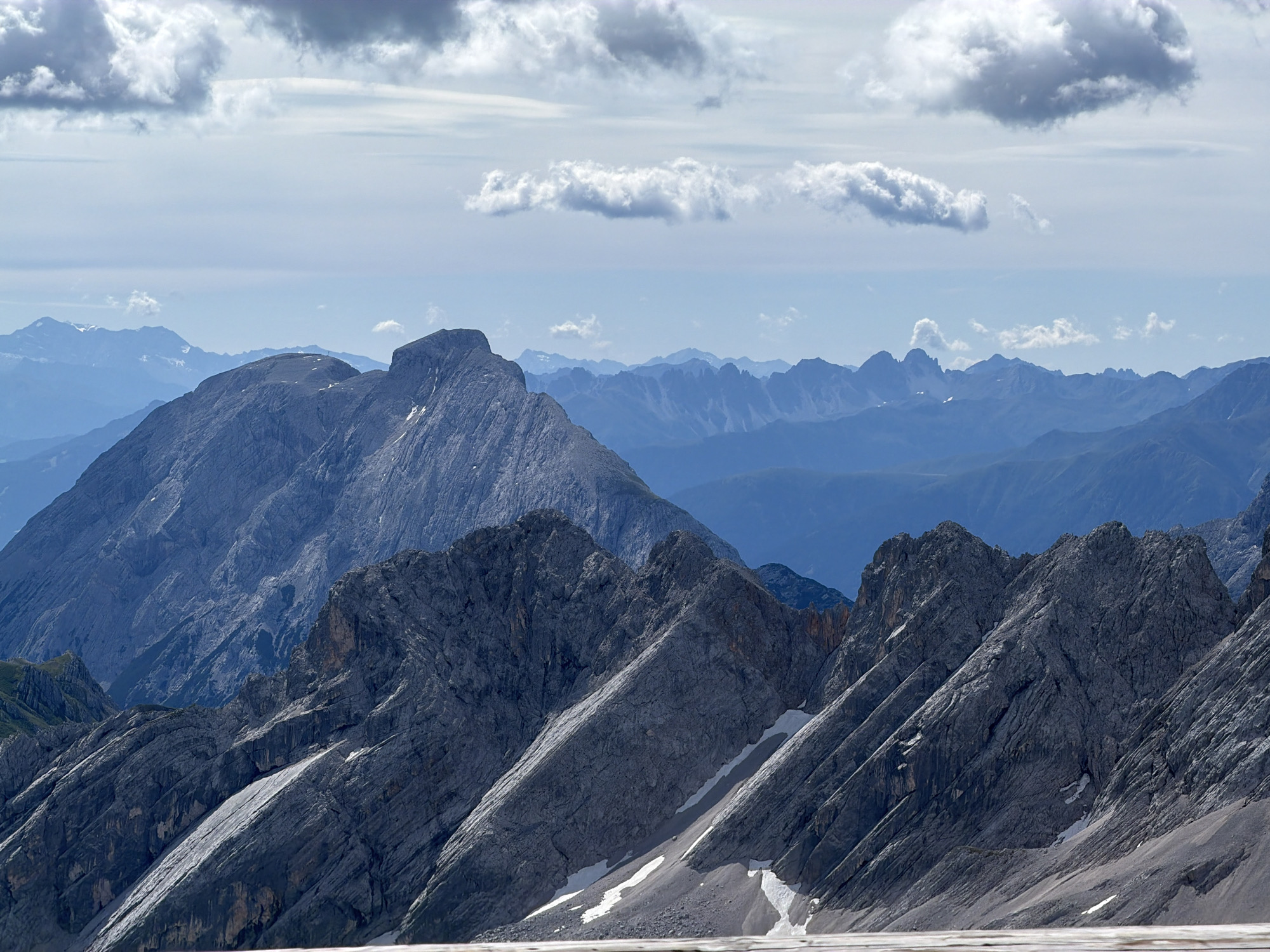 Alpine viewpoint visit amid snow groomers and rocky peaks, Austria
