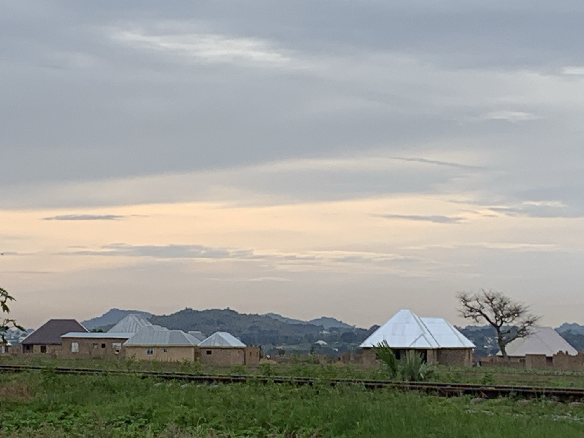 Overcast morning in Kuru Karama: fields, construction, and a moth on a curtain