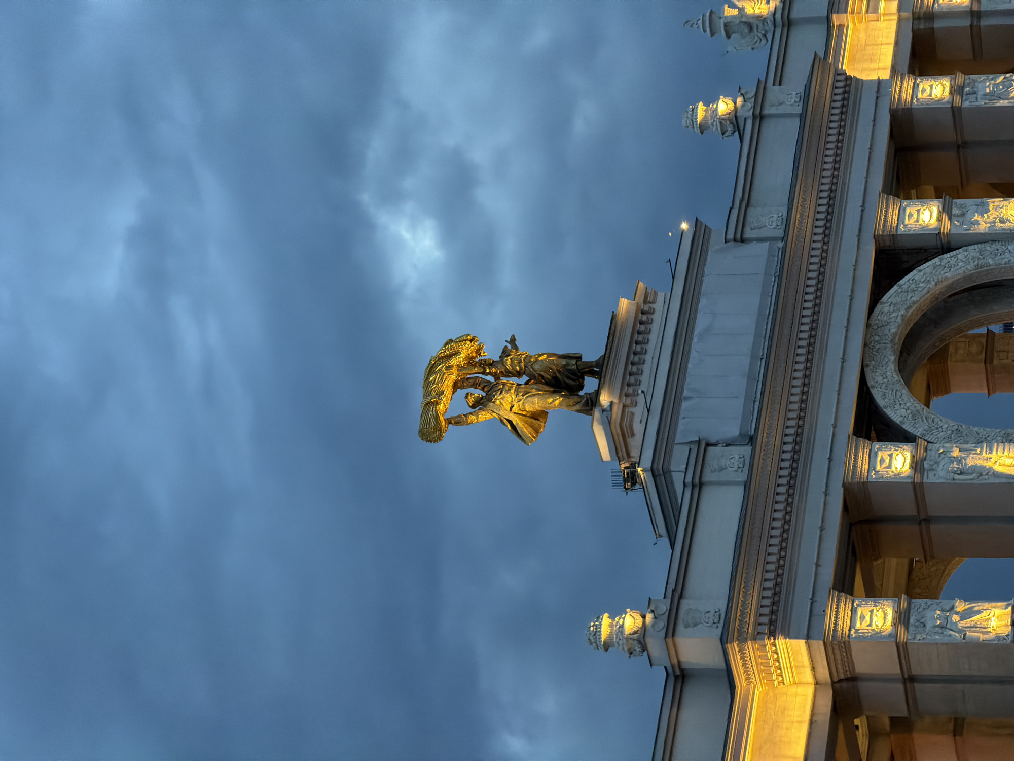 Moscow harvest wreath statue observed atop illuminated building