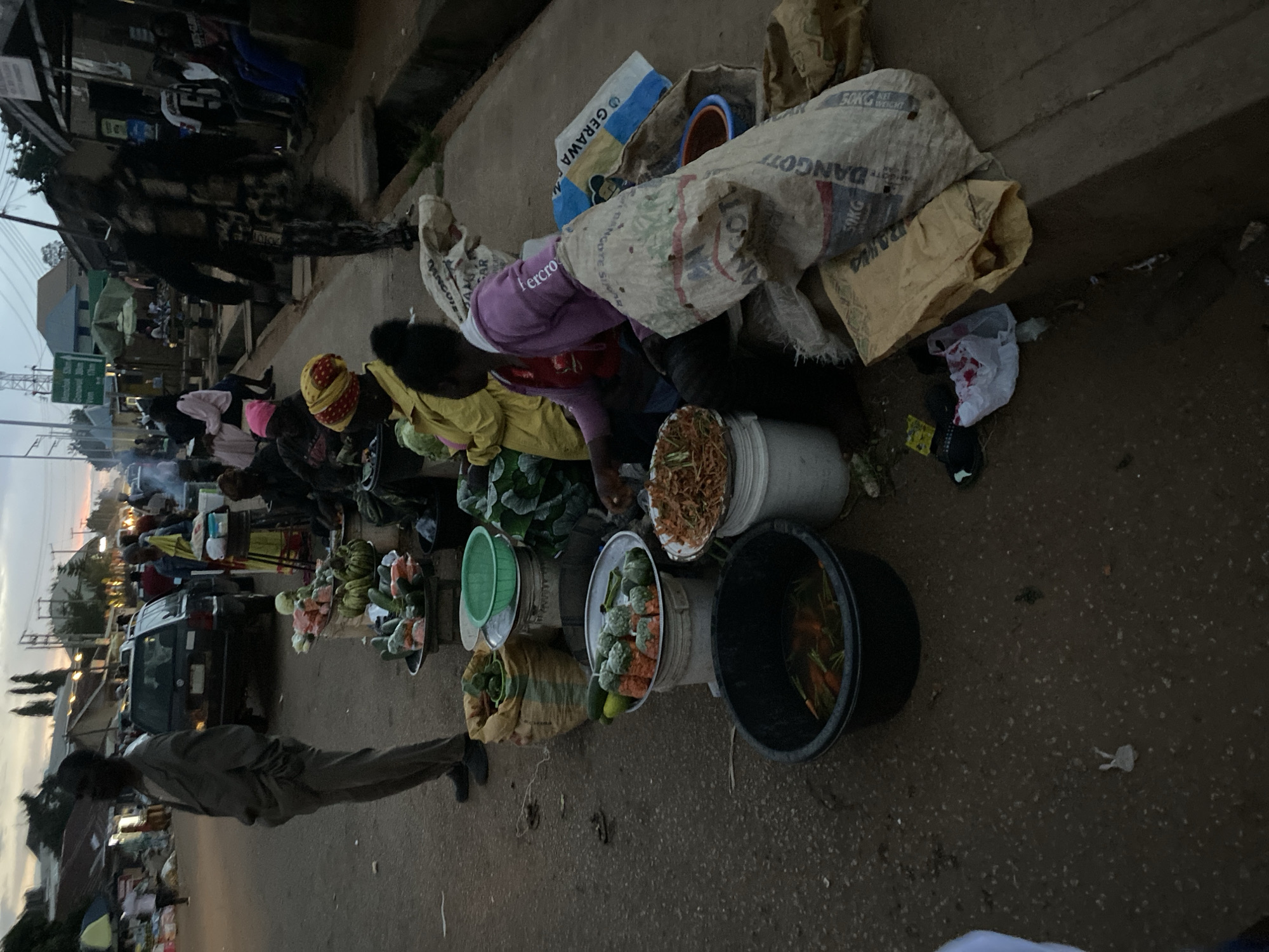 Roadside goods laid out at dusk in Bukuru, Nigeria