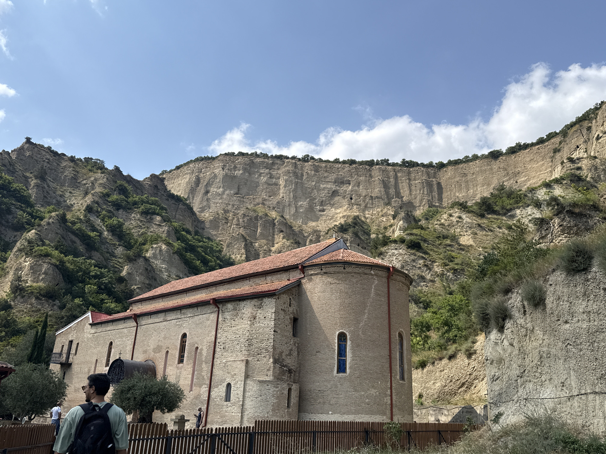 Stone church at the foot of rocky cliffs in Dzegvi, Georgia