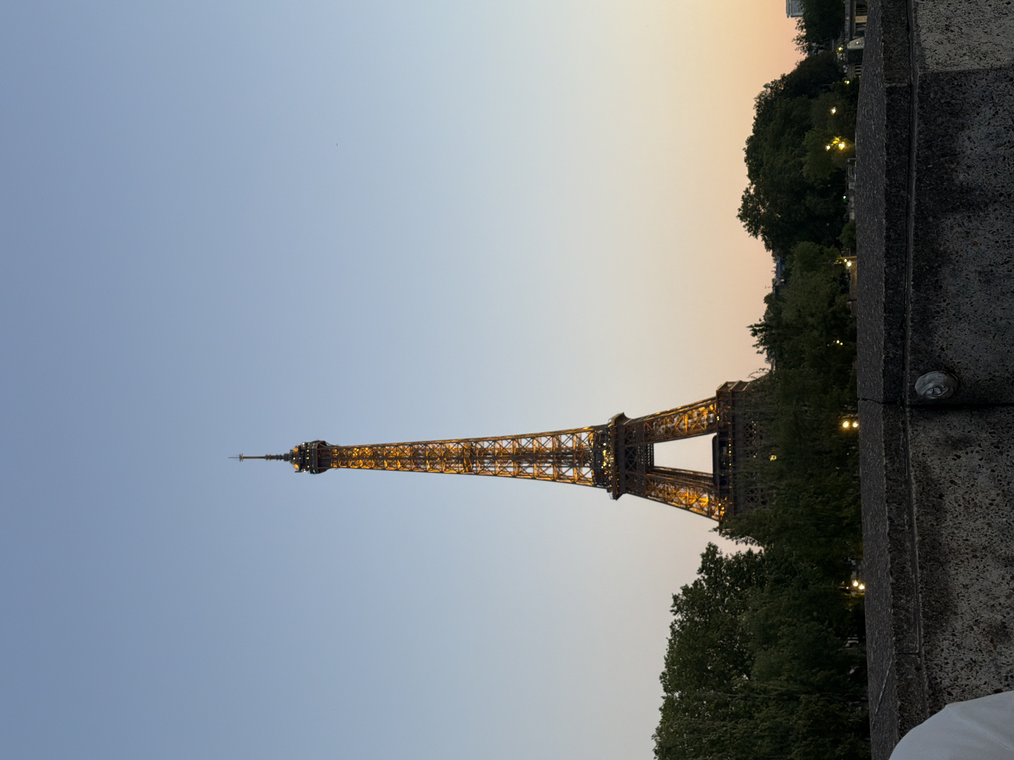 Eiffel Tower glowing at dusk, caught from multiple angles
