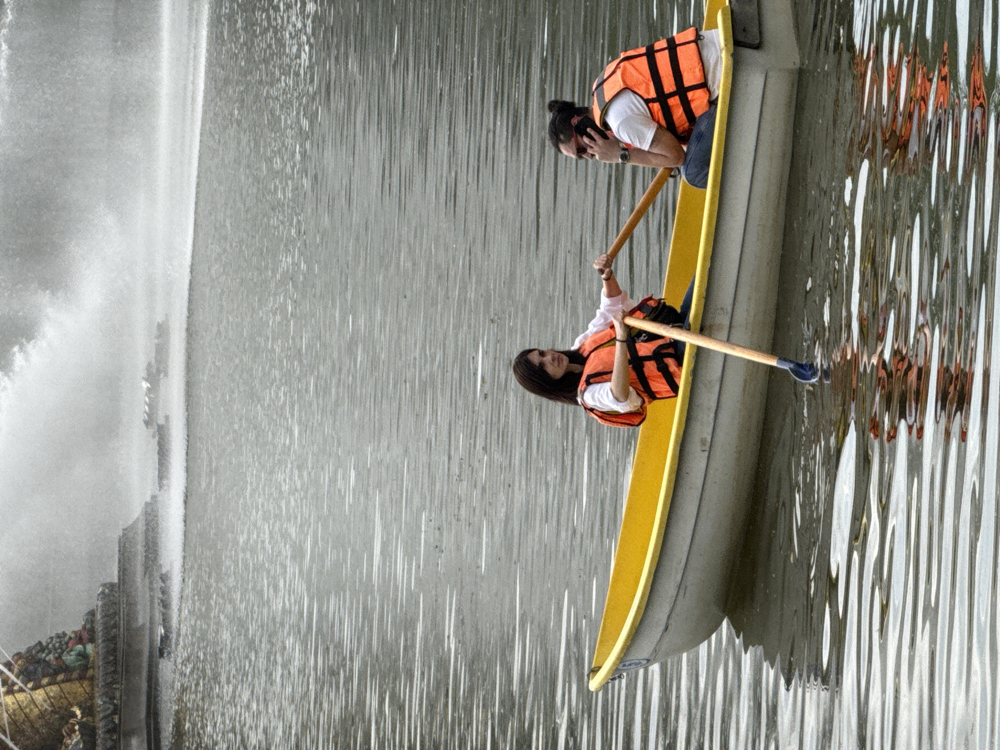 Women row boat near ornate fountain in Moscow park