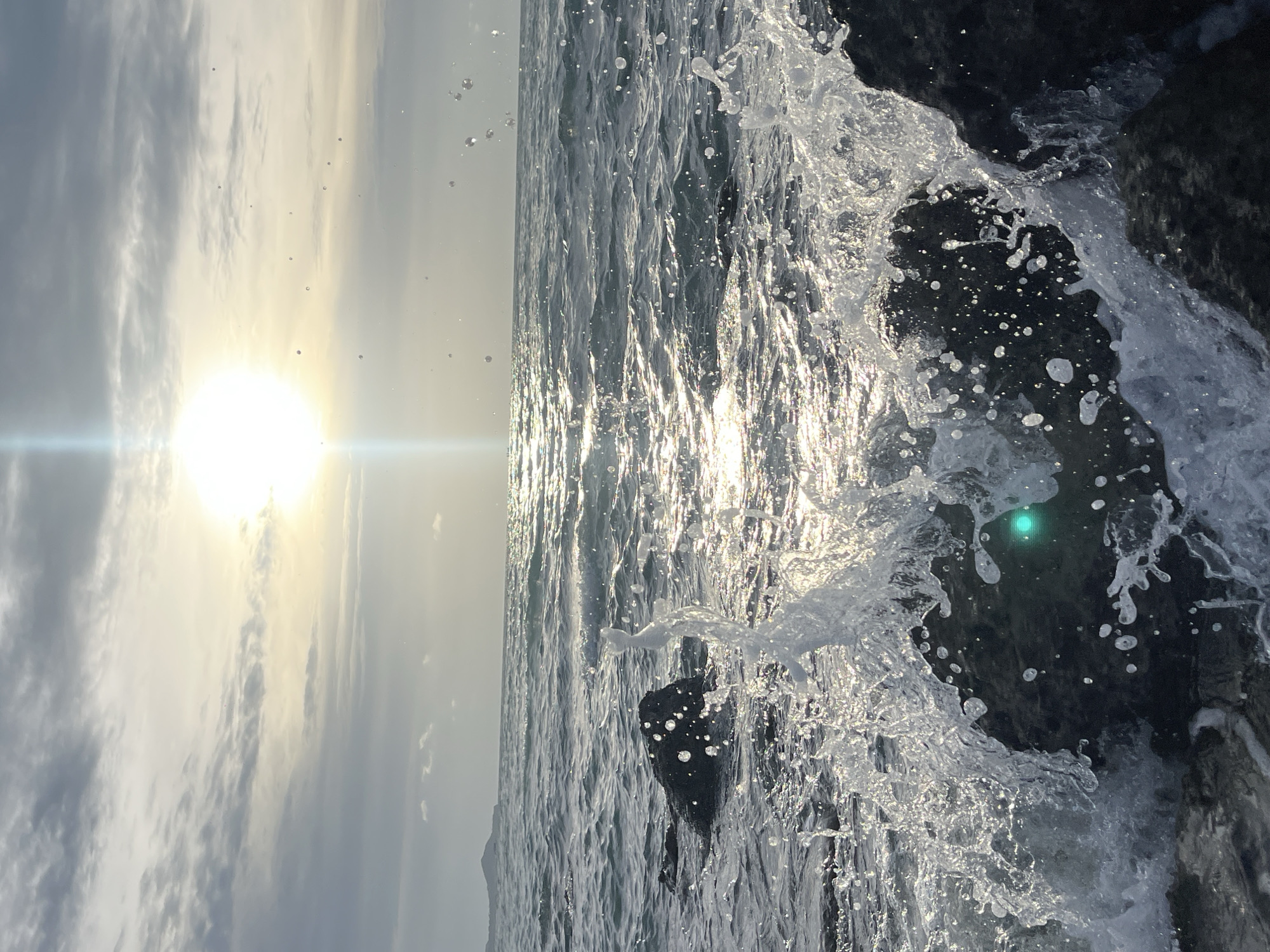 Waves breaking against Ko Samui rocks in bright morning light