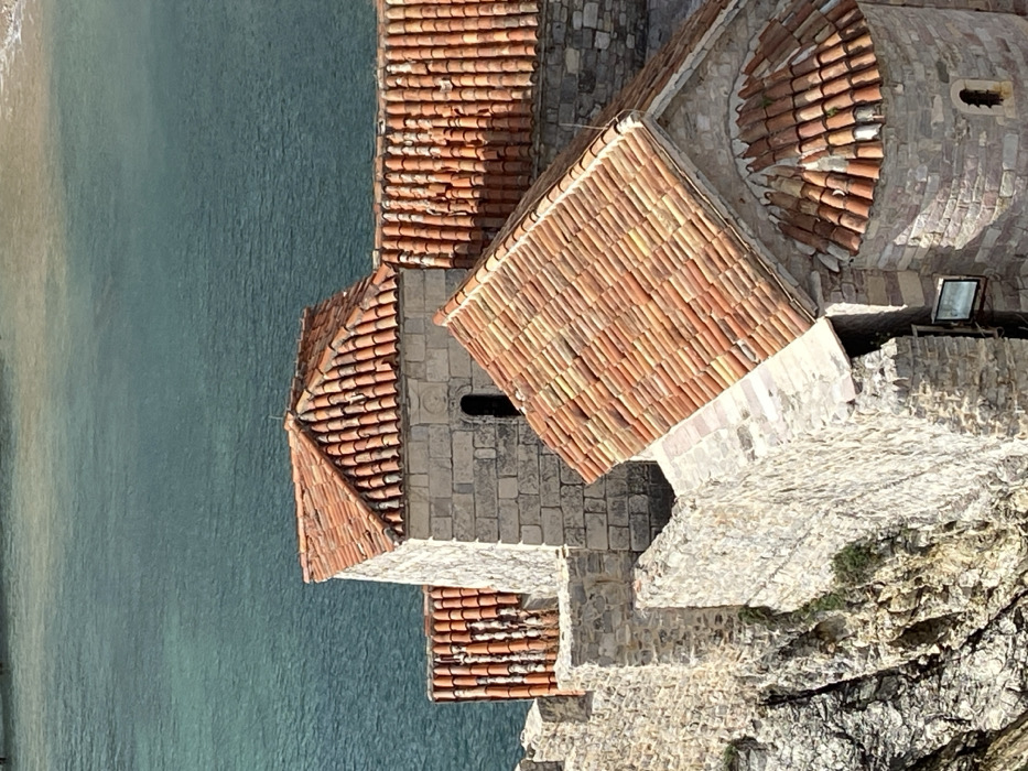 Tourist explores historic Budva Montenegro coastline and old town