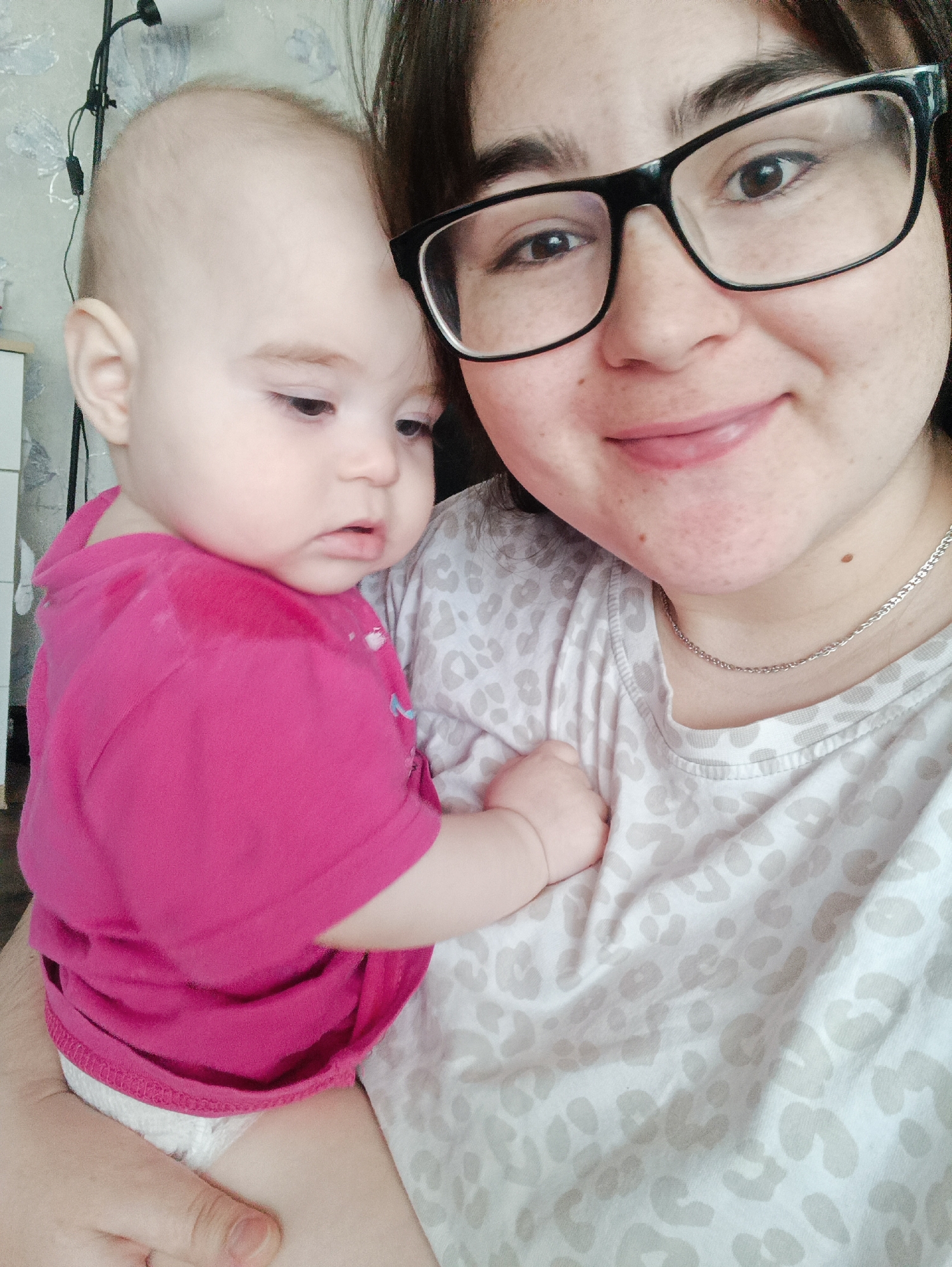 Woman and infant photographed in tender moment, Noviy Russia