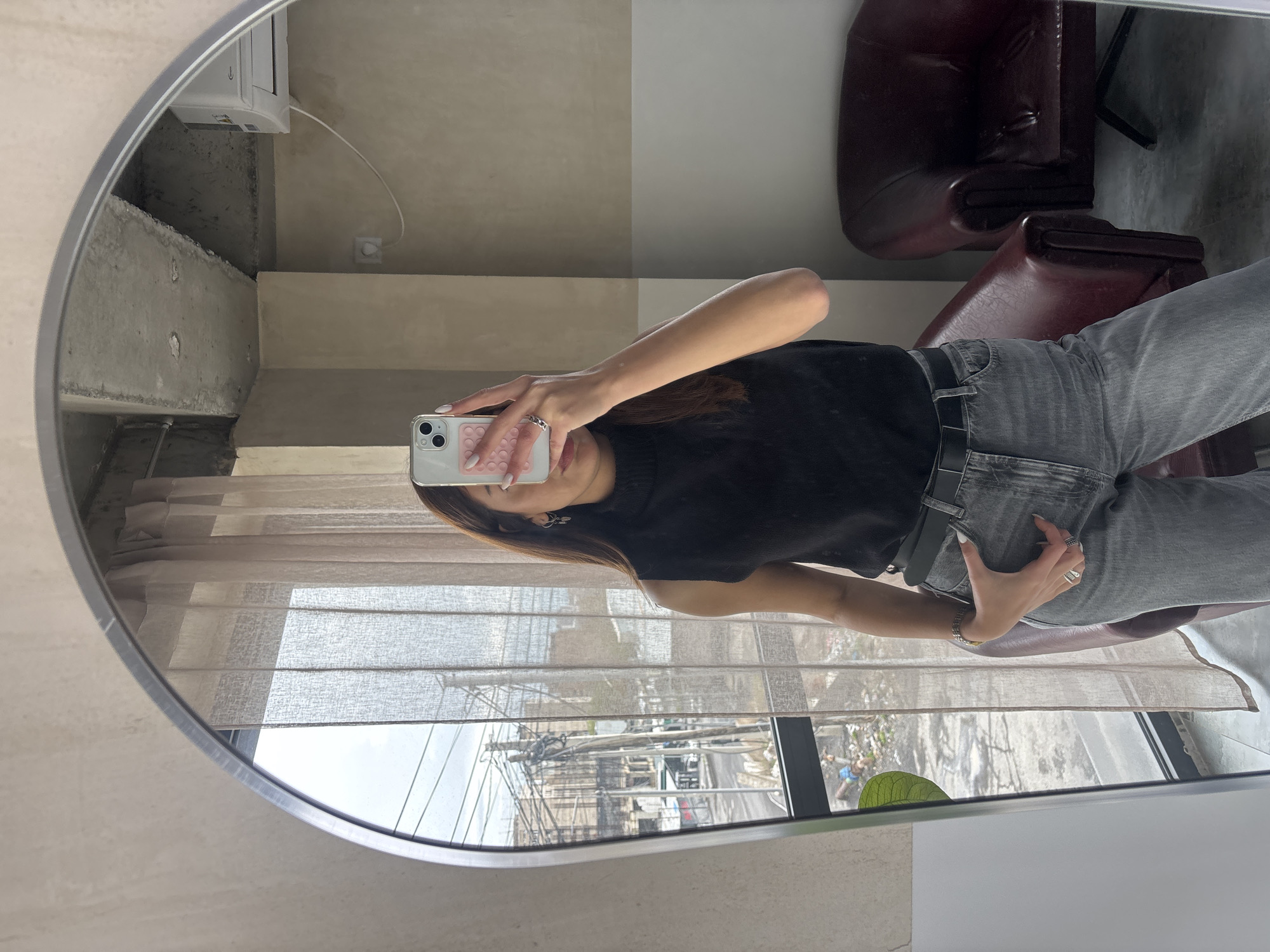 Woman takes mirror selfie in Zovuni, Armenia building