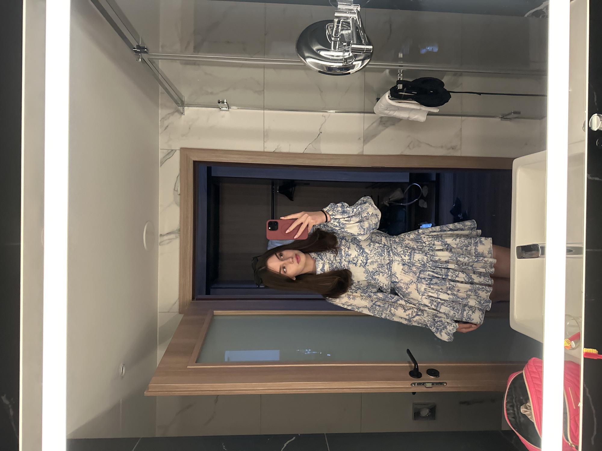 Mirror selfie in a marble bathroom, blue floral dress