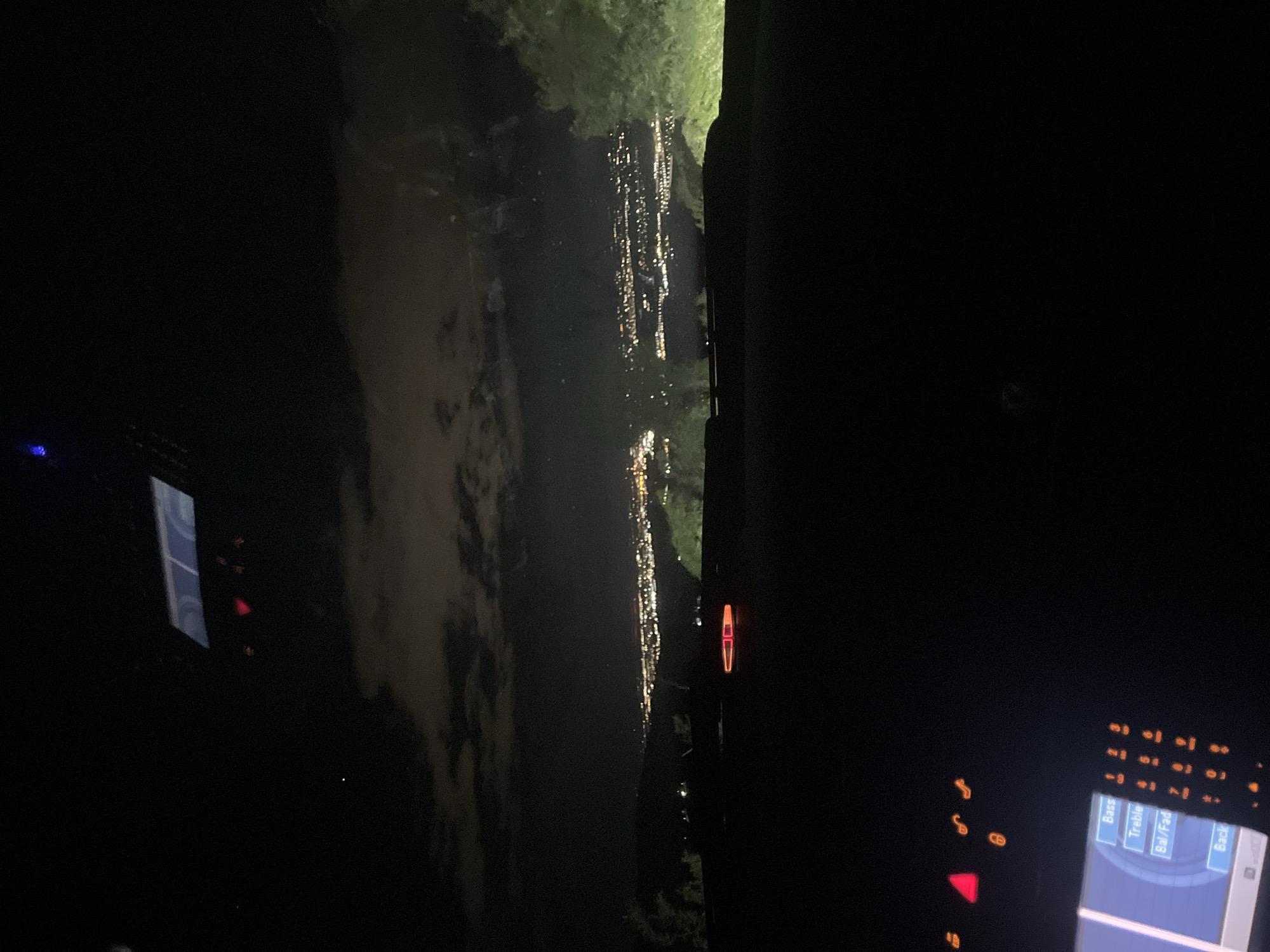 Nighttime city lights reflection captured from vehicle in Asenovgrad
