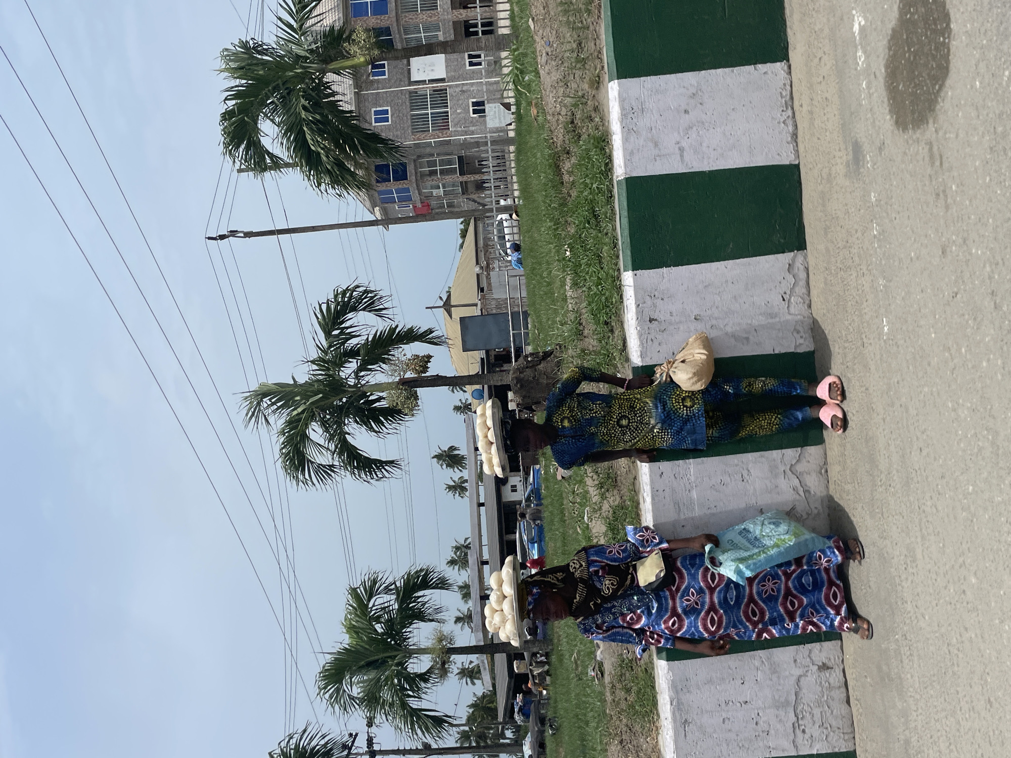 Street vendors sell food on Badagry sidewalks