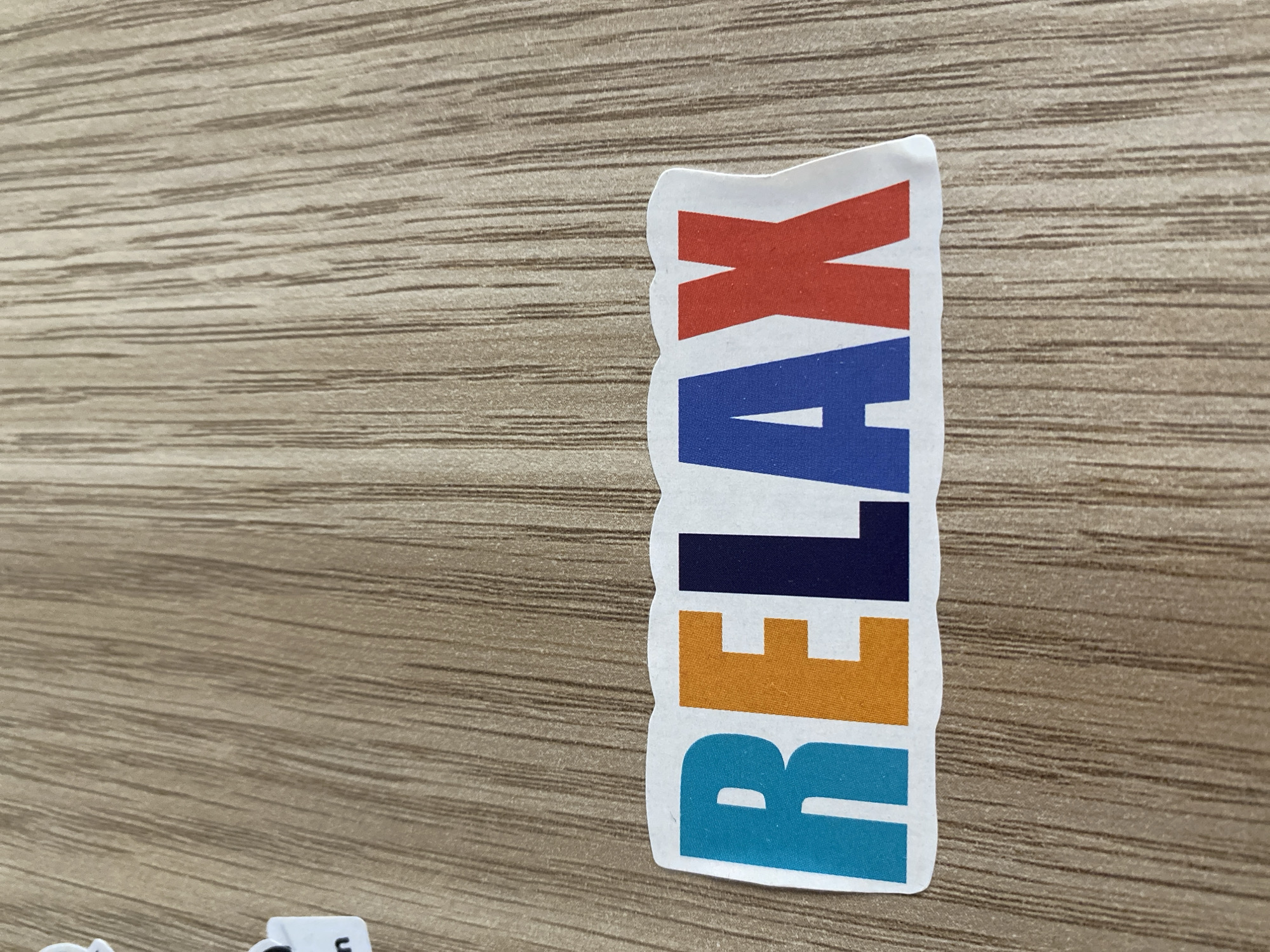 Sticker collection and Armenian everyday objects on a wooden surface