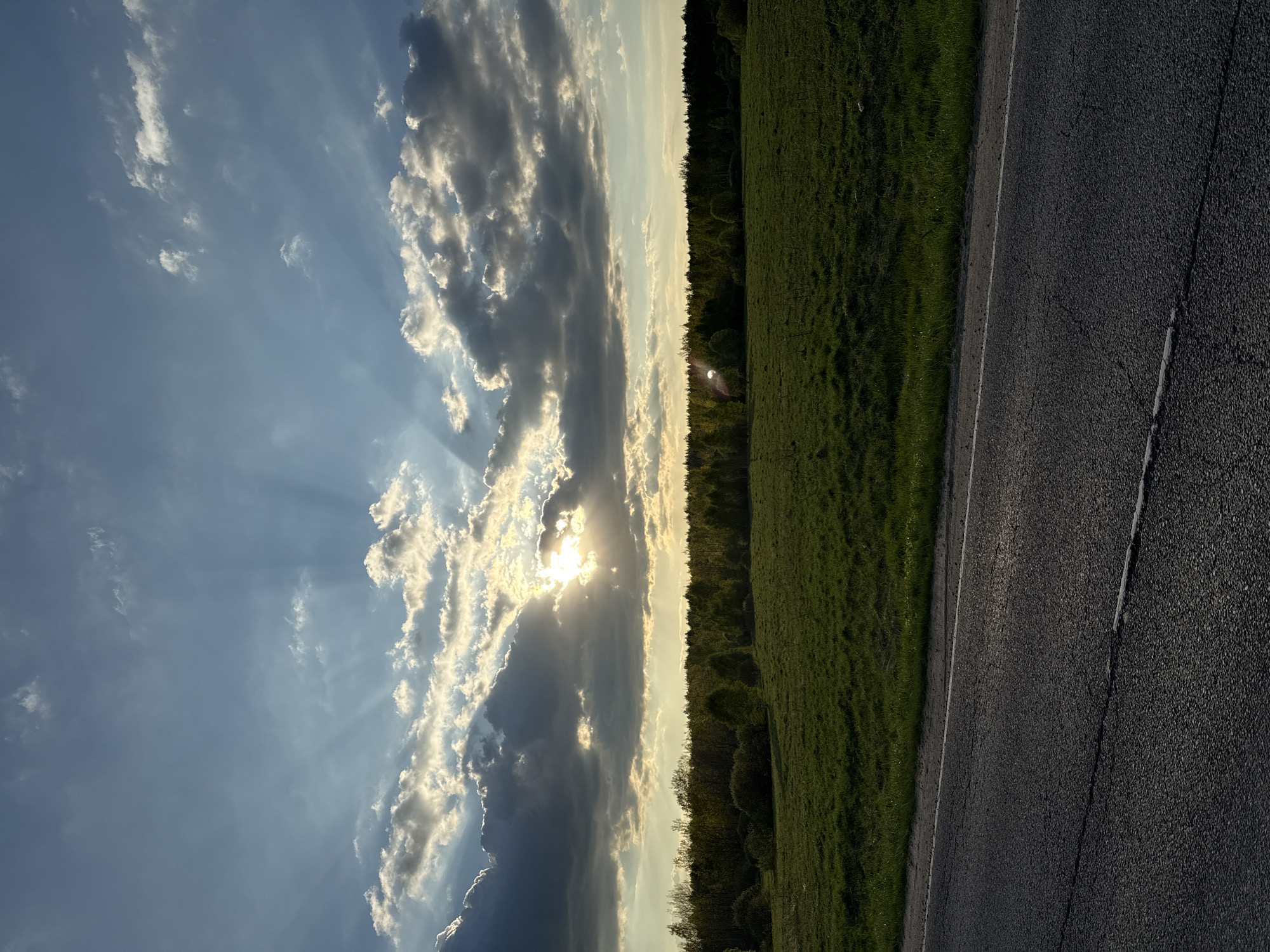 Sunlight breaks through clouds over rural Russian landscape
