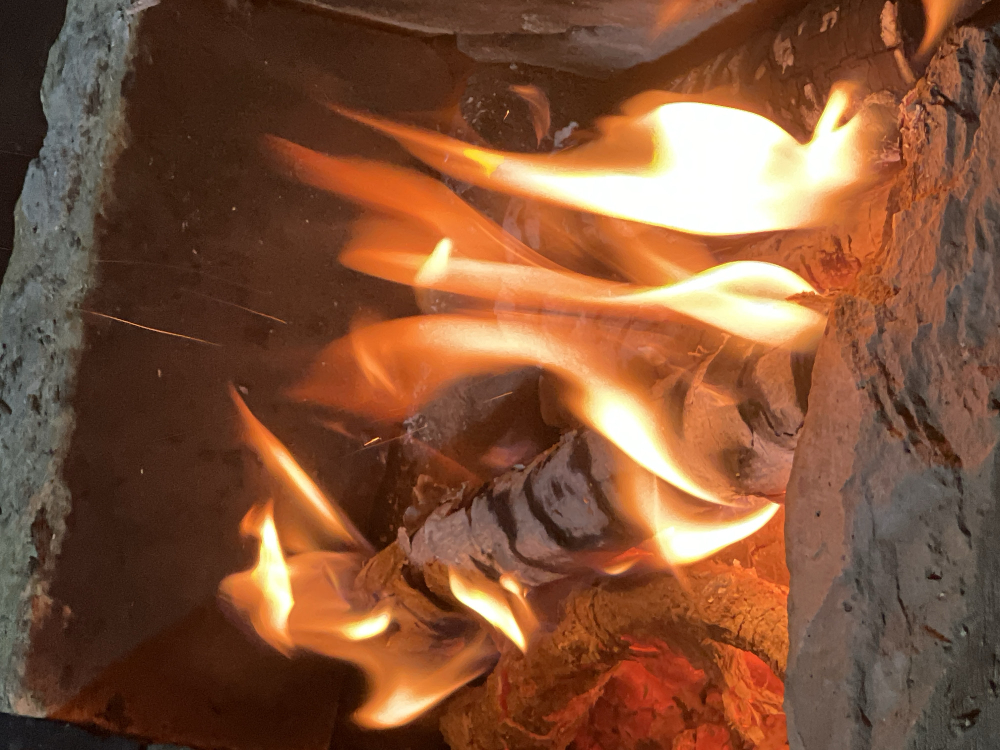 Wood fire burning down to glowing embers, Oskemen