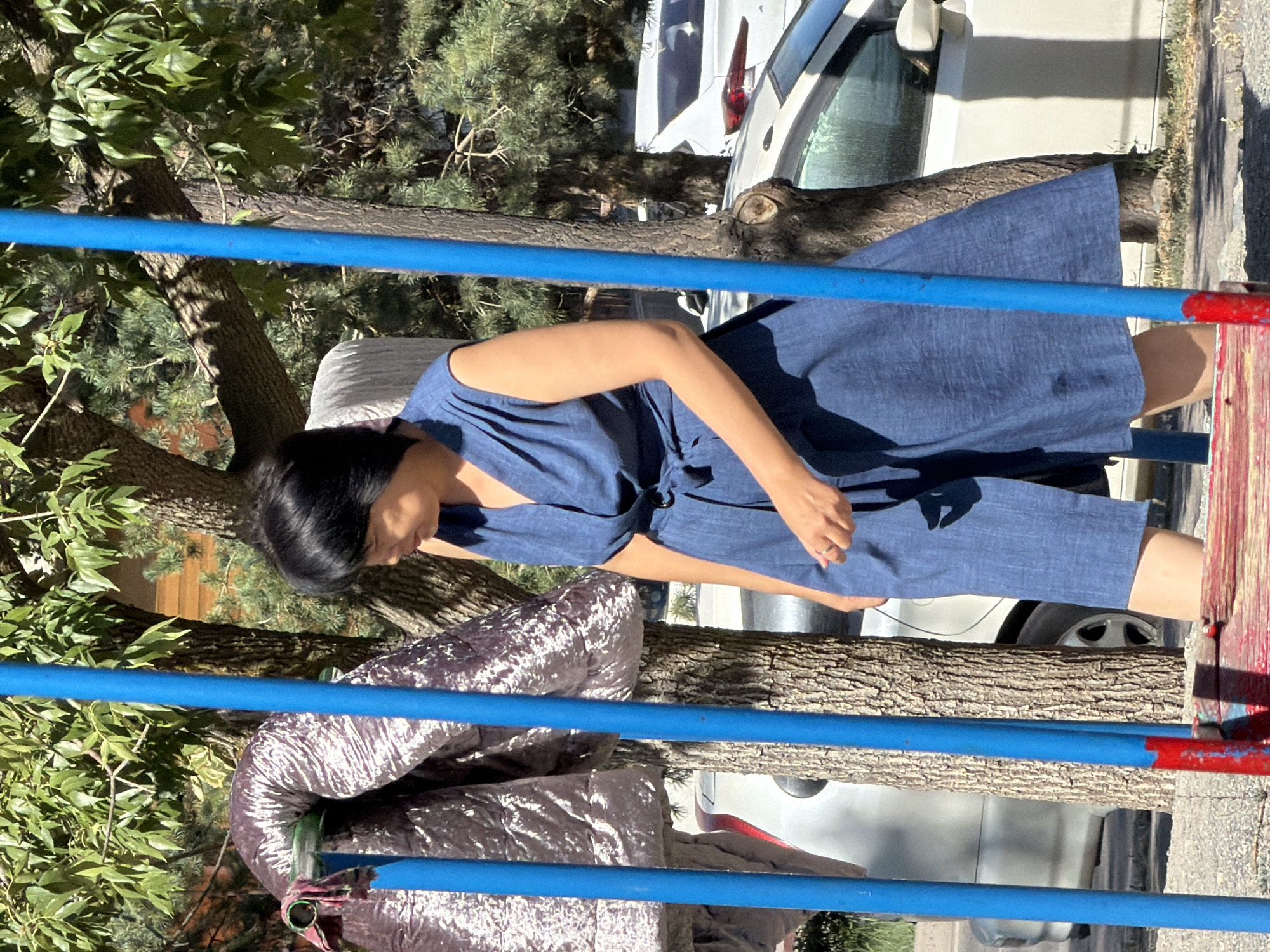 Quiet outdoor moments near a residential playground on a sunny day