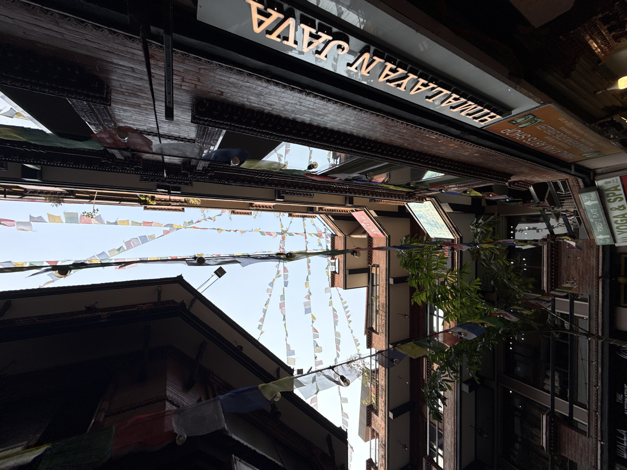 Morning coffee walk through prayer flag-lined Kathmandu streets