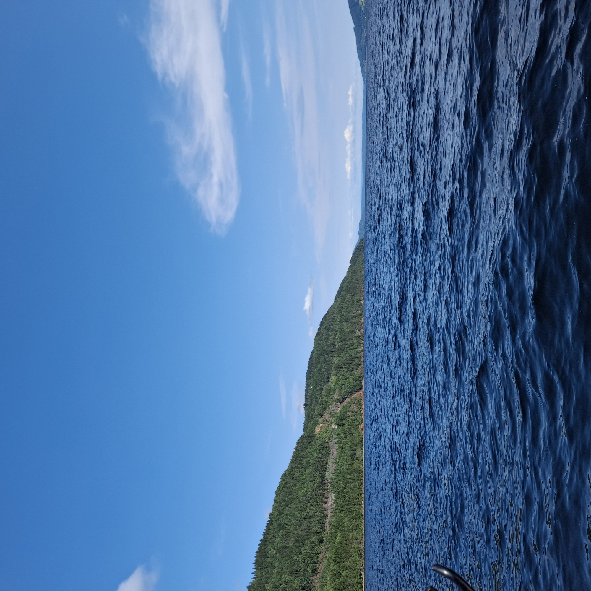 Boating across calm blue waters near Minnesund, Norway