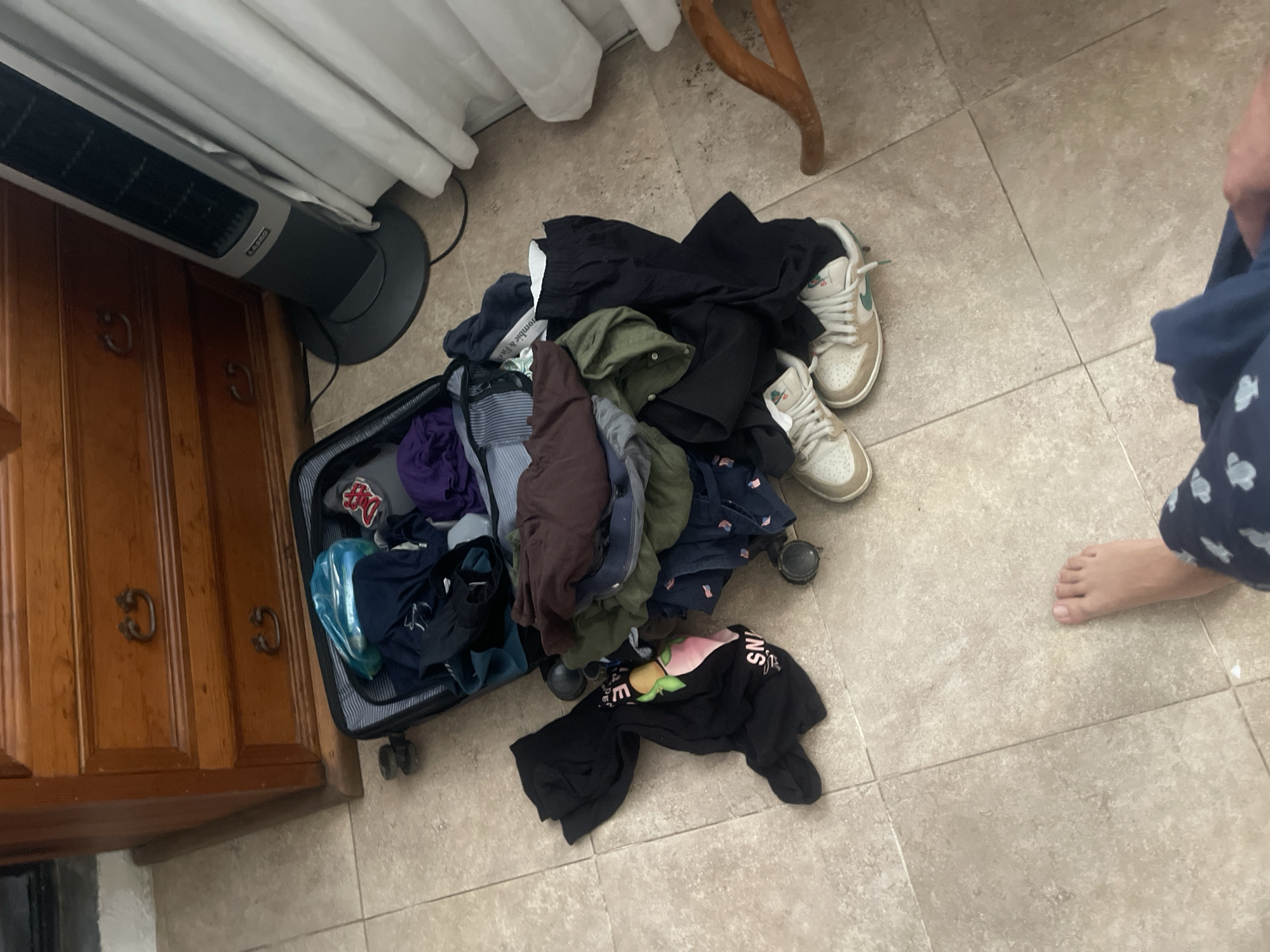 Overflowing suitcase with clothes documented in Oaxaca City residence