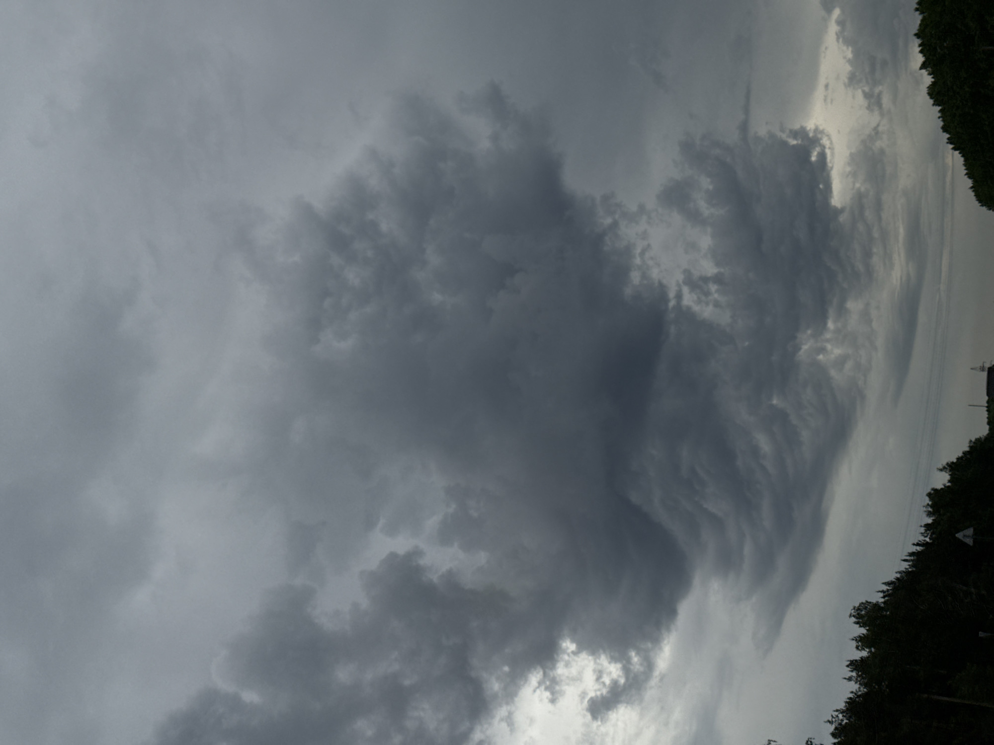 Heavy clouds gather over rural road in Бизяки, Russia