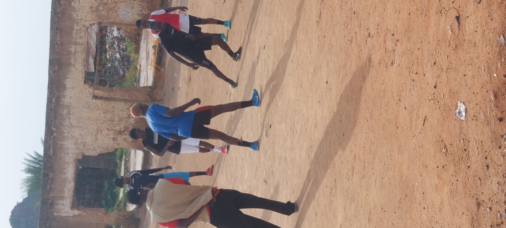 Informal football on a dirt field in Bukuru, Nigeria