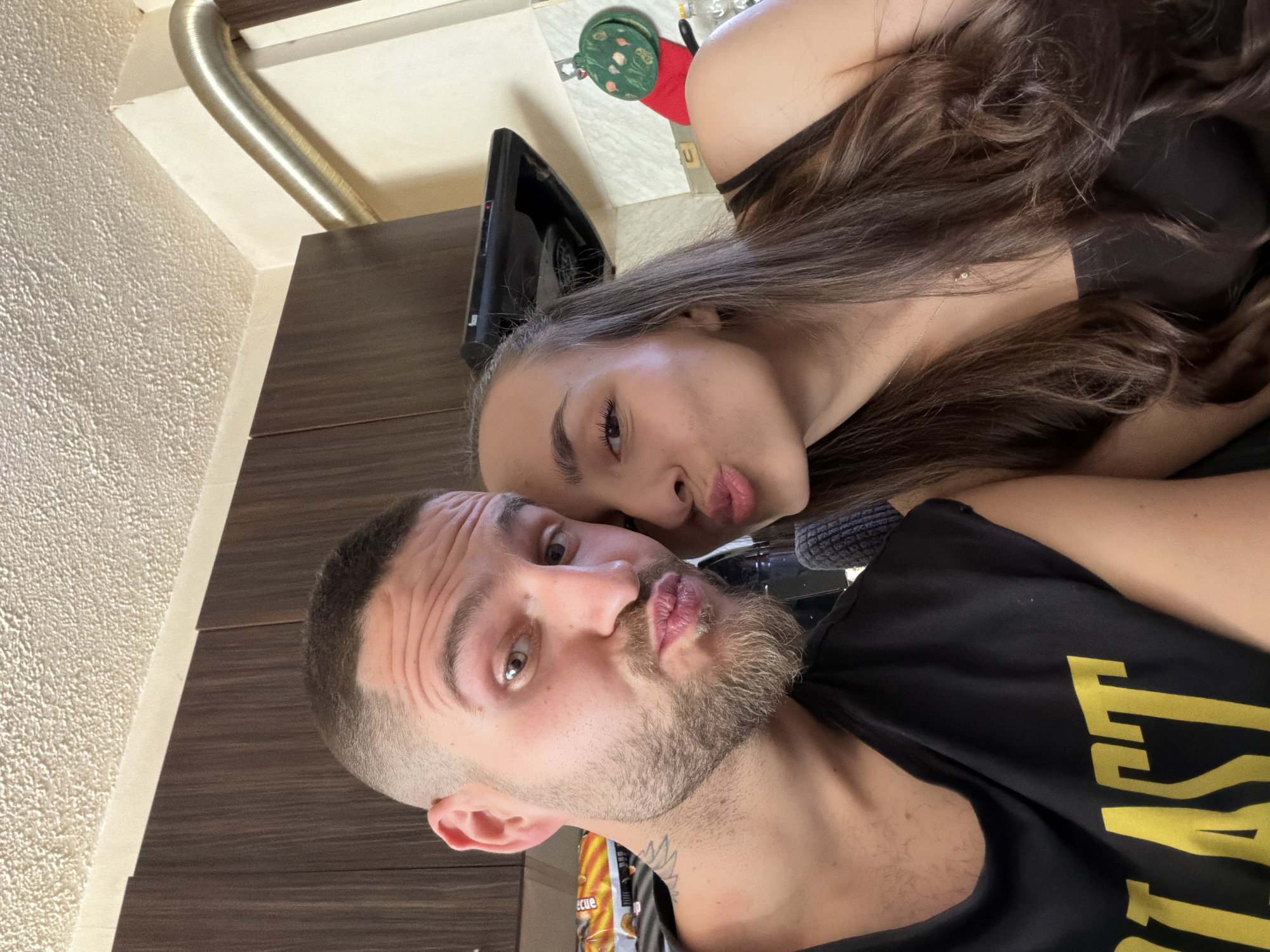 Couple photographs selfies together in Sofia kitchen setting