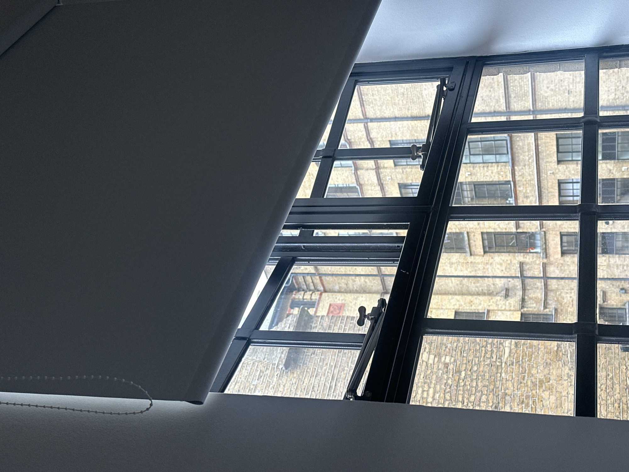 London resident views brick building through apartment window