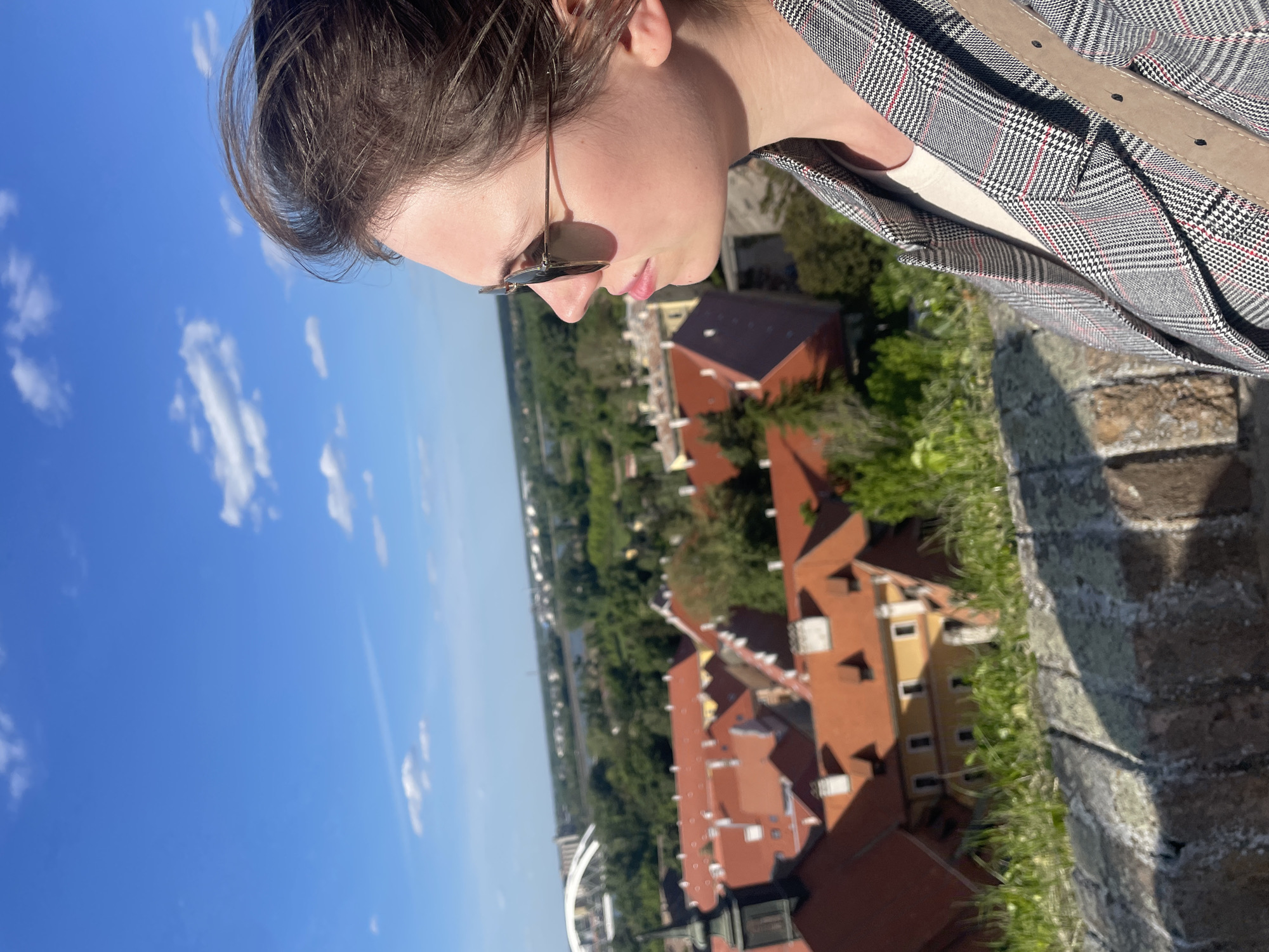 Tourist photographs Petrovaradin Fortress overlook on sunny afternoon