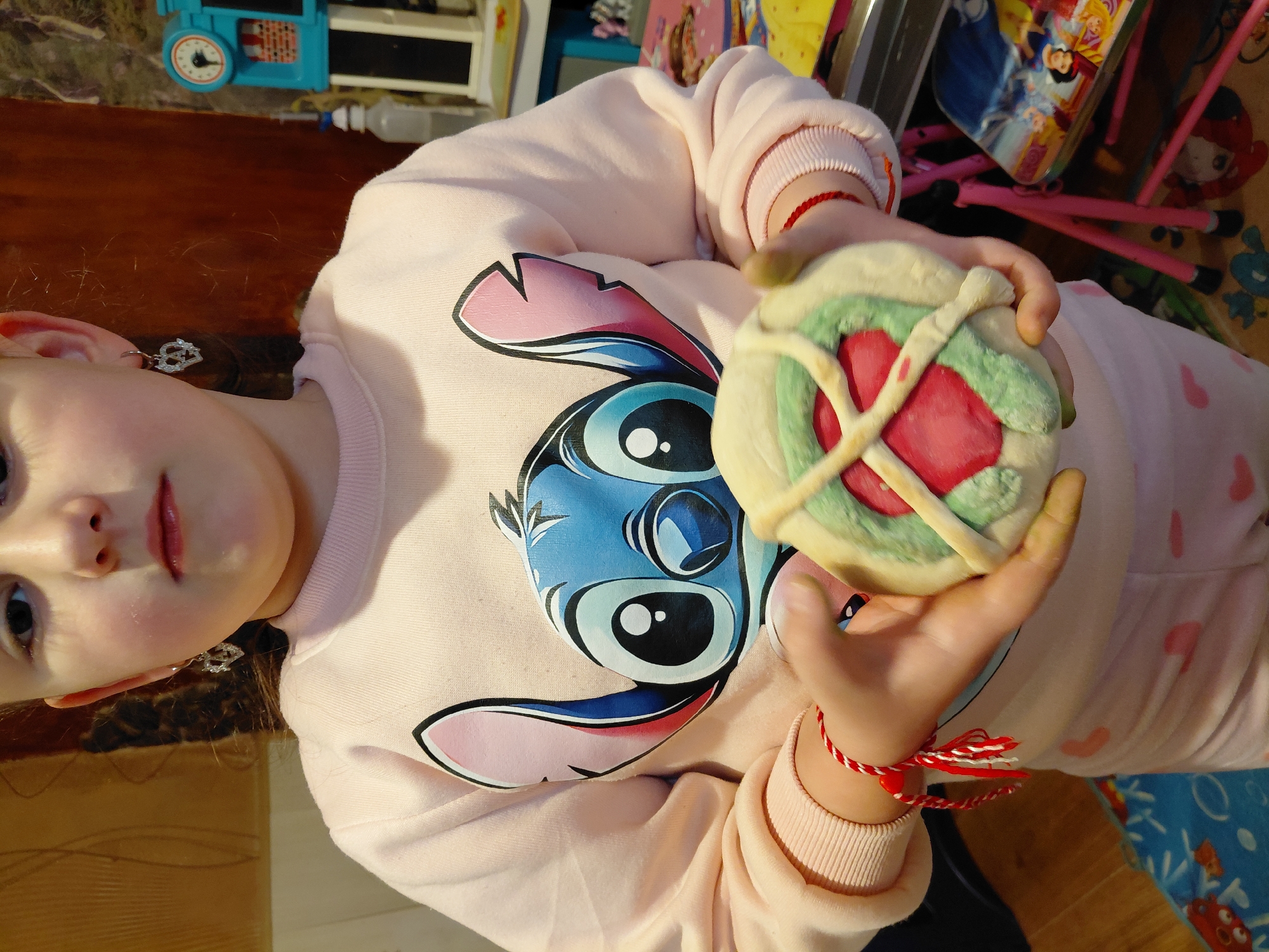 Young girl displays handmade cookies and artwork in Sofia