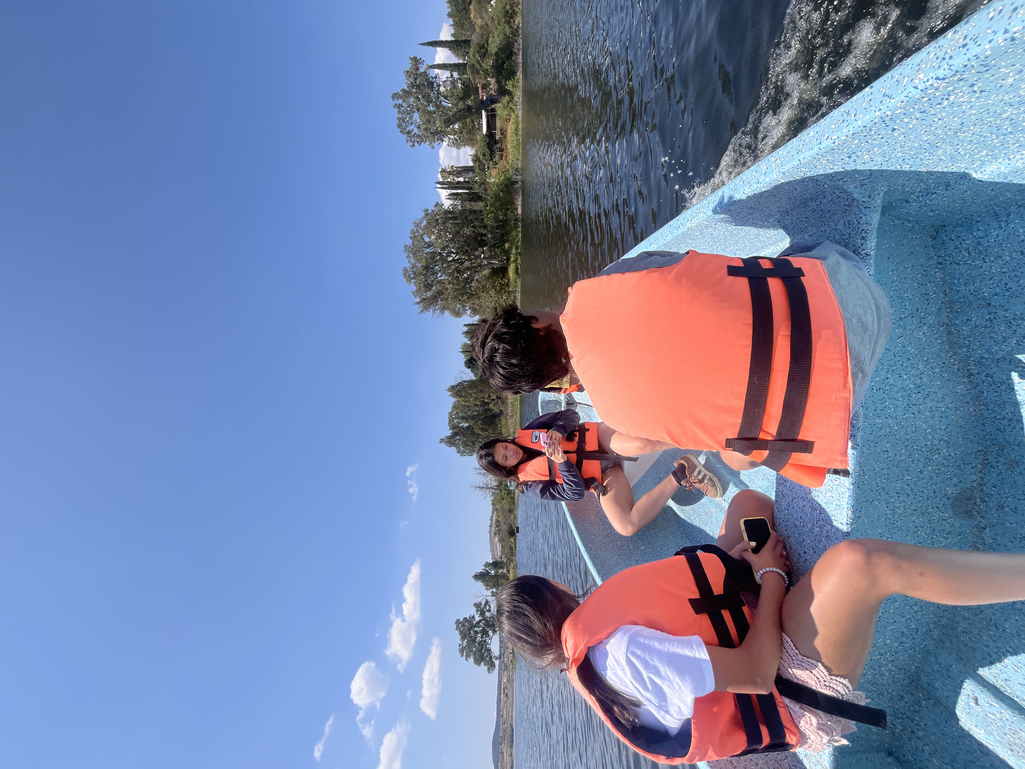 Three youths in life vests boat on Valsequillo Lake