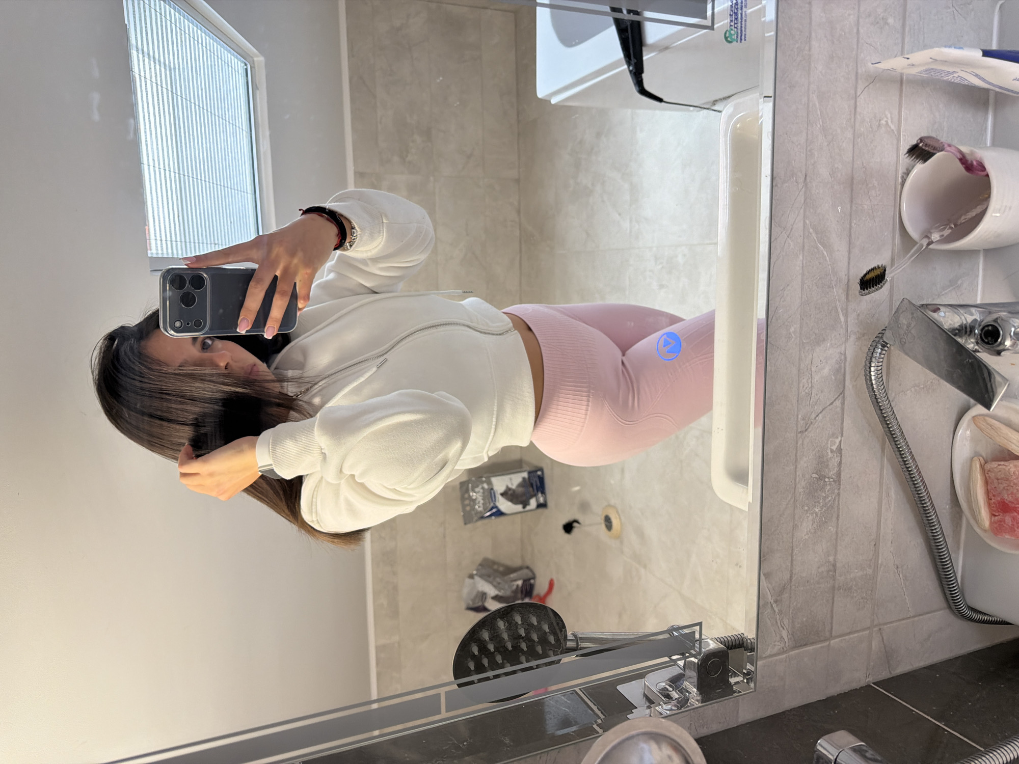 Woman photographs herself in bathroom, walks on pathway in Gabrovo
