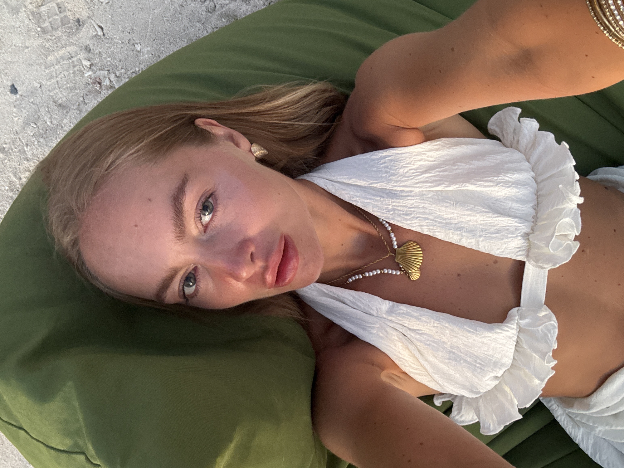 Woman relaxes on beach cushion in Indonesia