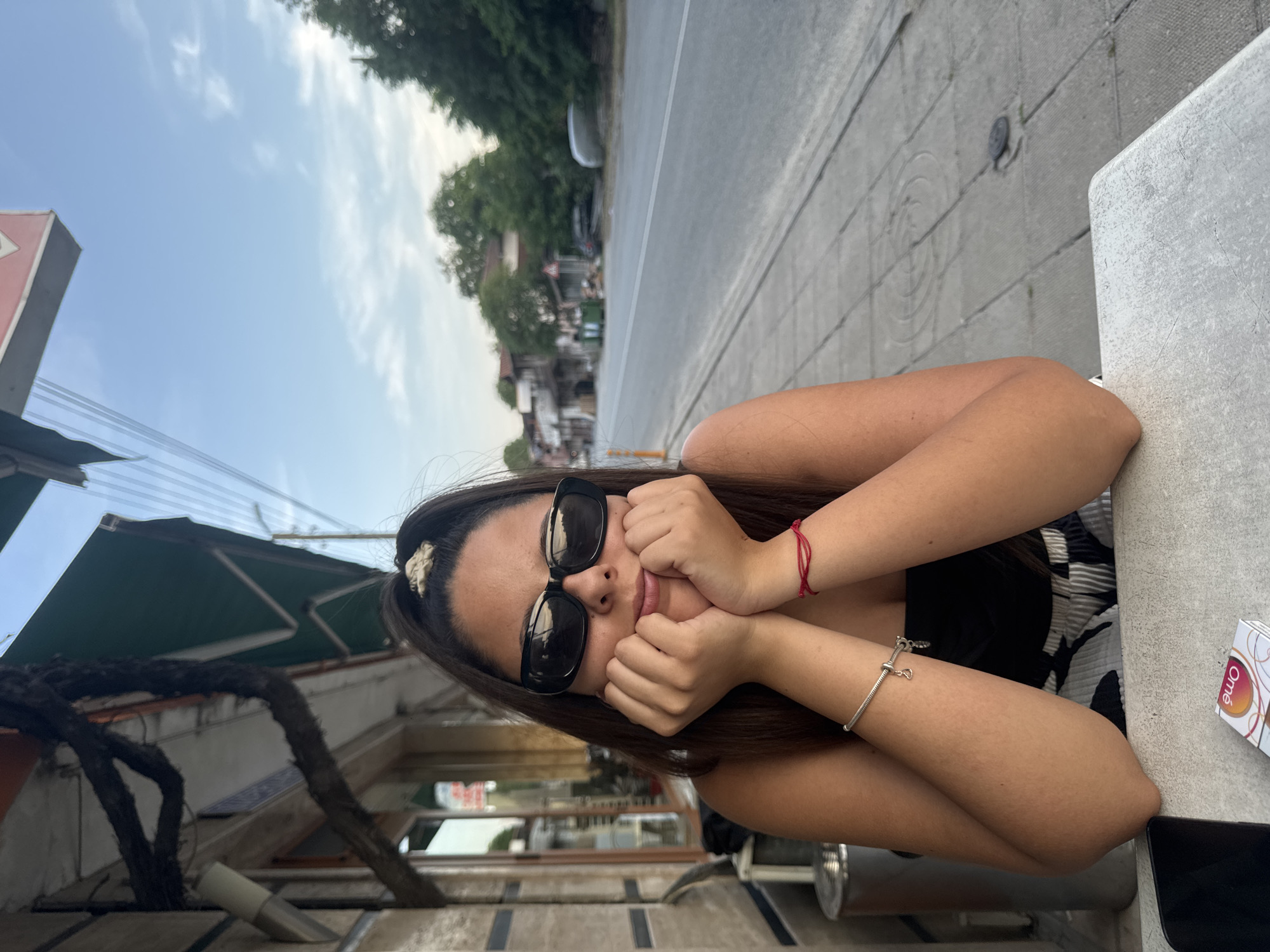 Woman photographed at outdoor table in Bulgarian village