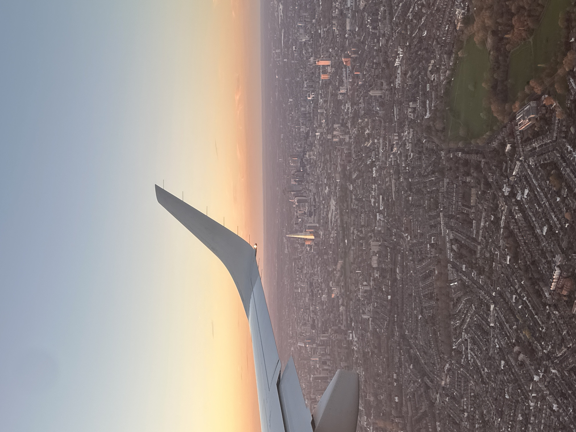 Aircraft captures aerial view of London cityscape at sunset