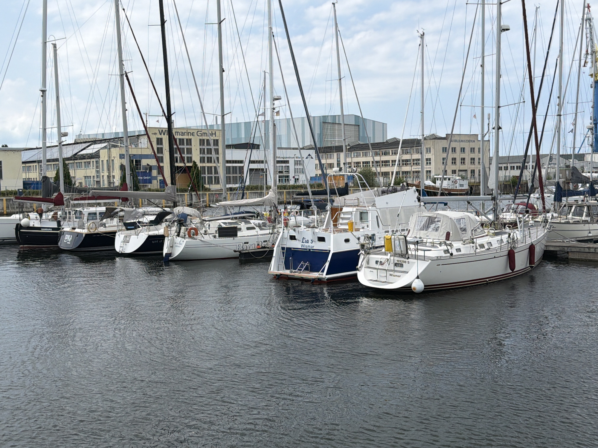 Wismar harbor packed with sailboats on a grey summer day